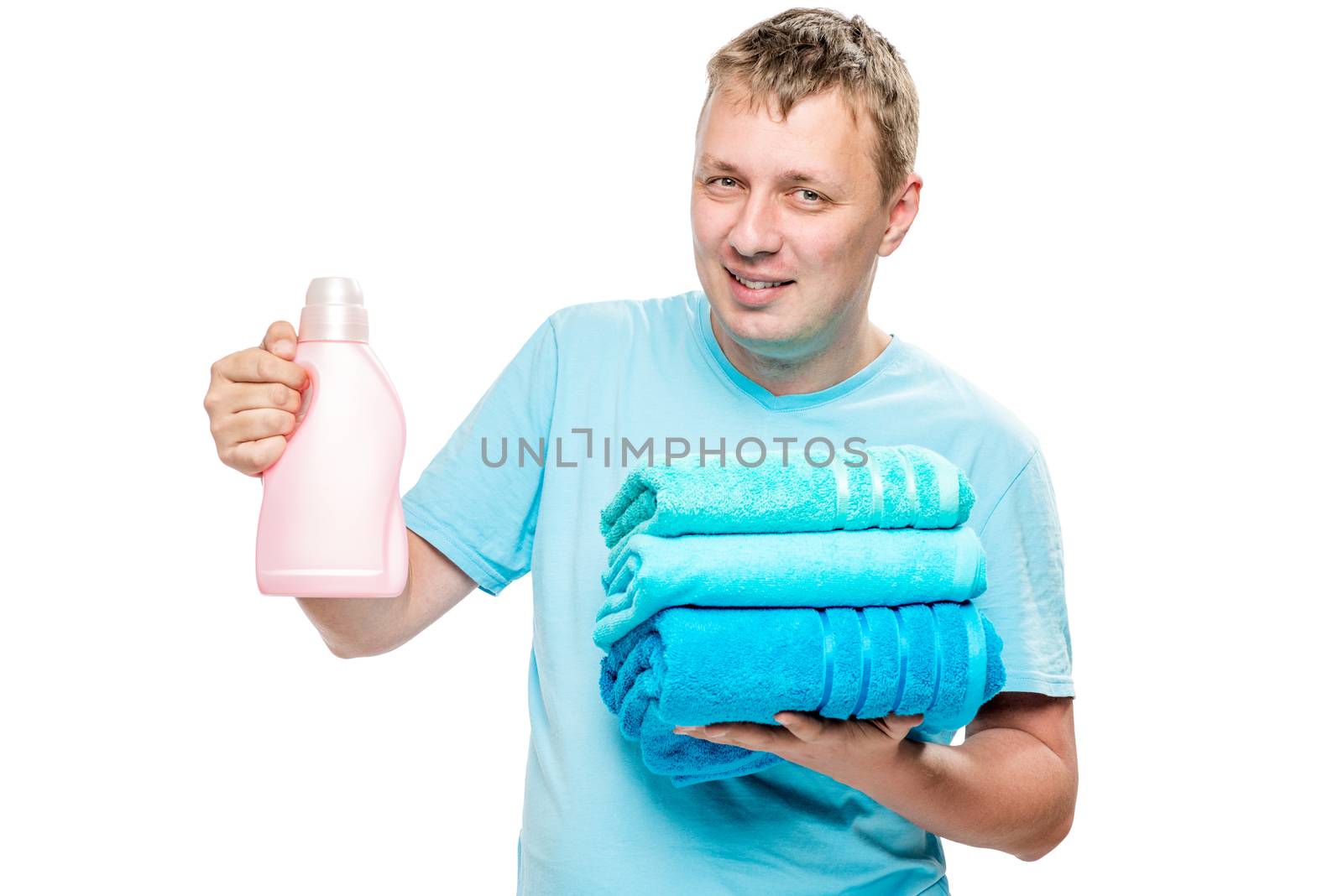 portrait of happy husband with clean towels and gel for washing clothes on white background