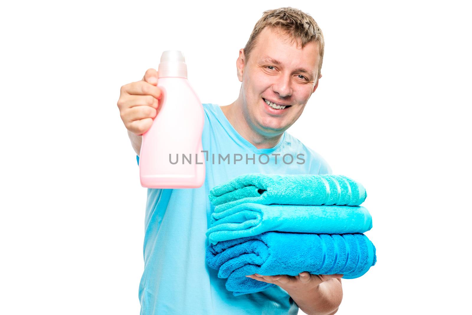 happy householder with clean towels and a gel for washing clothes on a white background