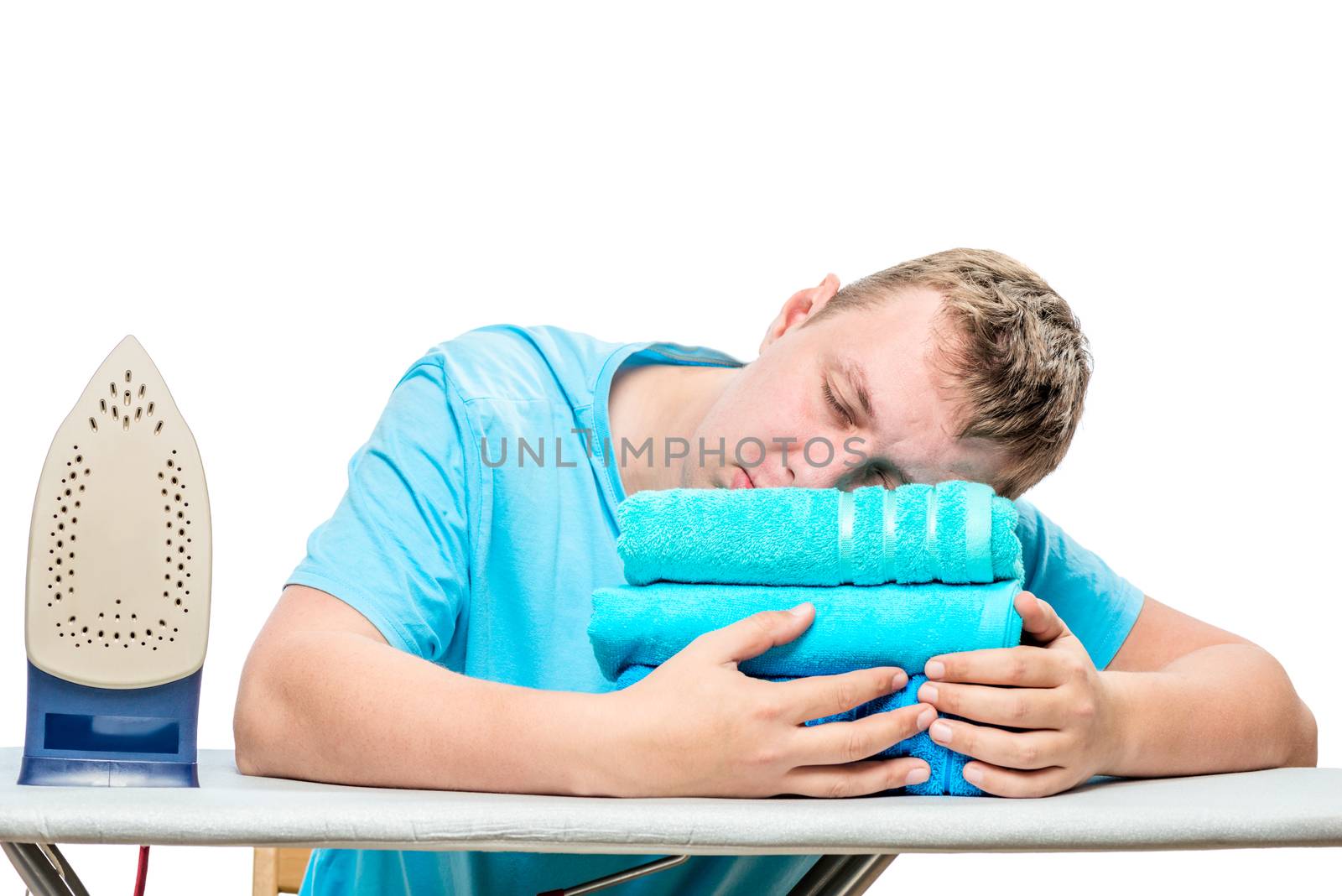 the man at the ironing time fell asleep on the ironing board, his head is on the towel