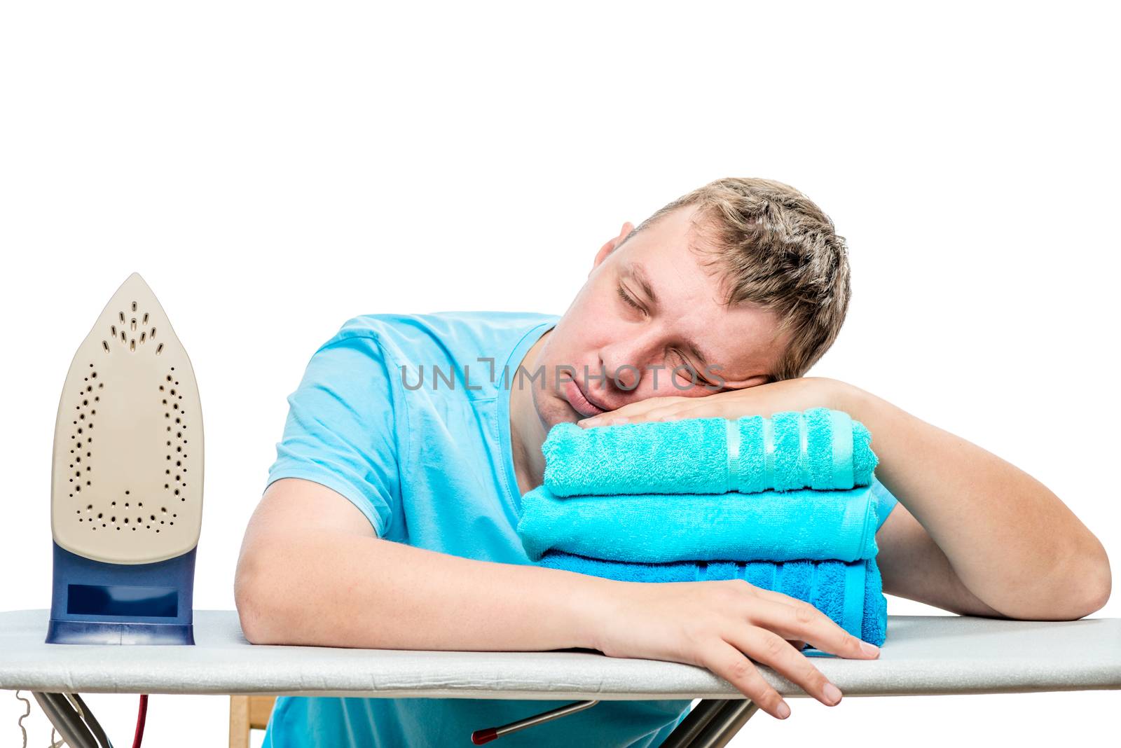 a tired man stroked the towels and fell asleep on the ironing board, his head lying on the towel