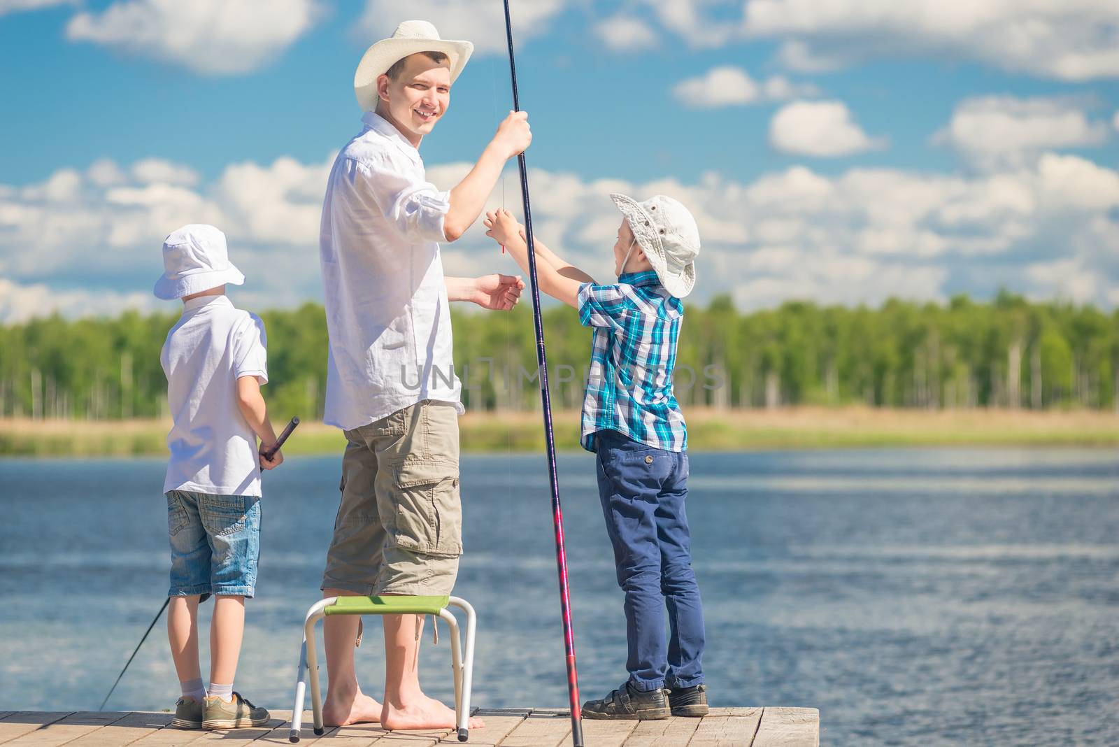 happy father with sons on a fishing trip, portrait in full lengt by kosmsos111