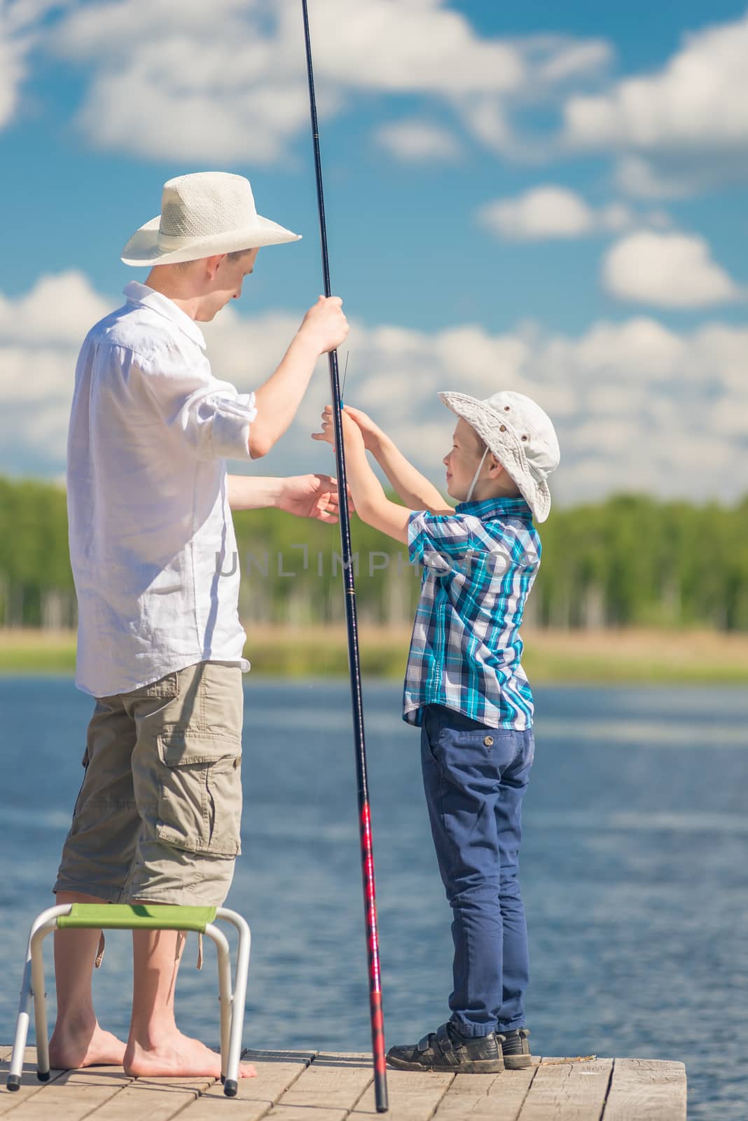 son helps his father to fish in the lake by kosmsos111