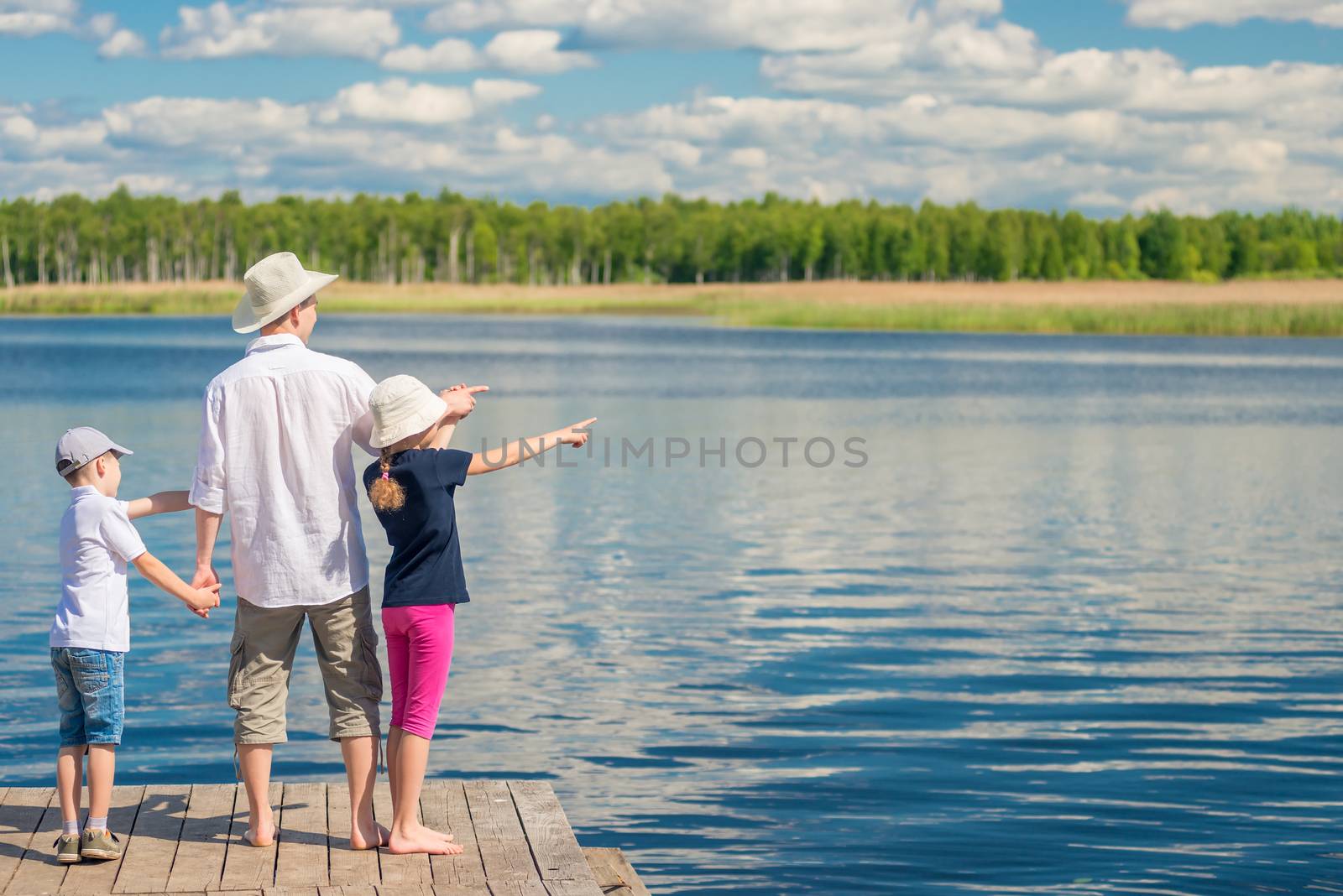 happy family on a pier near a picturesque lake by kosmsos111