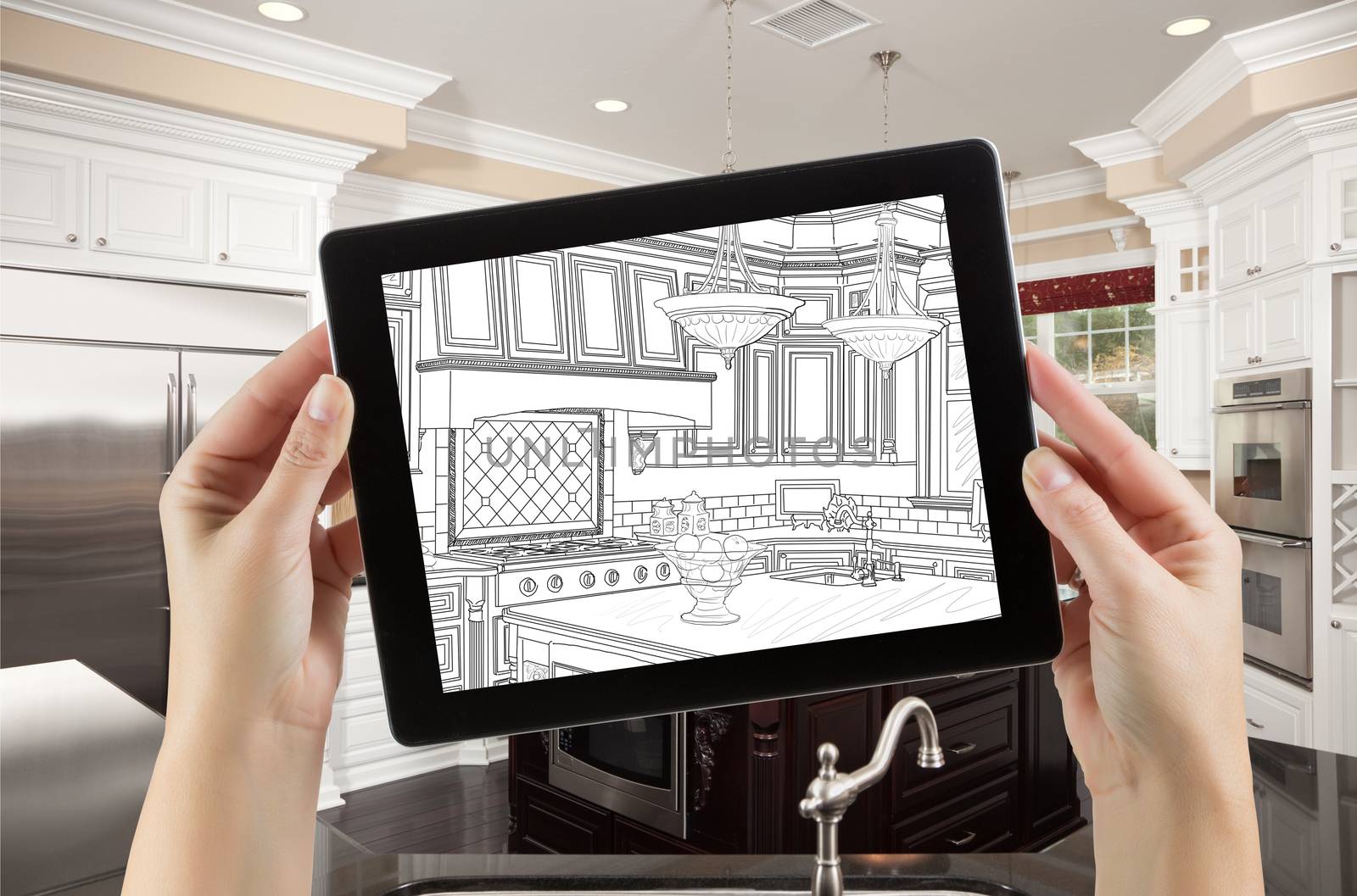 Female Hands Holding Computer Tablet with Drawing on Screen of Kitchen Behind. by Feverpitched