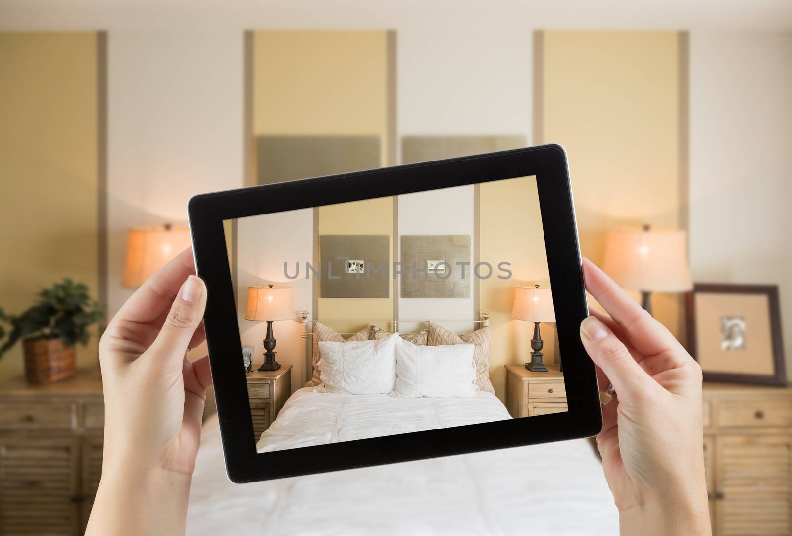 Female Hands Holding Computer Tablet In Room with Photo on Screen. by Feverpitched