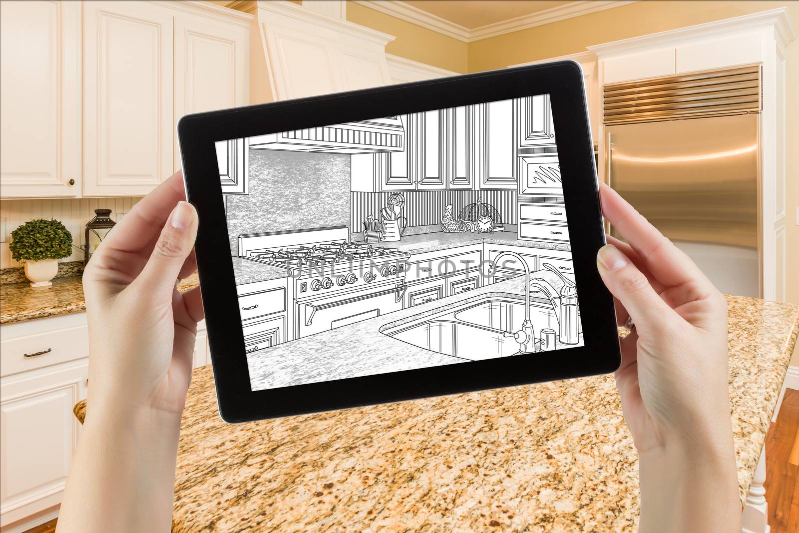 Female Hands Holding Computer Tablet with Drawing on Screen of Kitchen Behind.