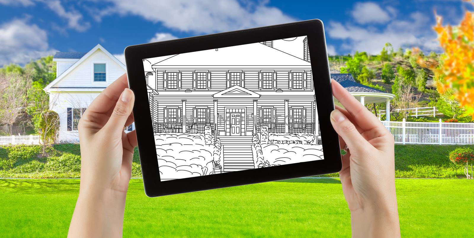 Female Hands Holding Computer Tablet with House Drawing on Screen, Photo Behind. by Feverpitched