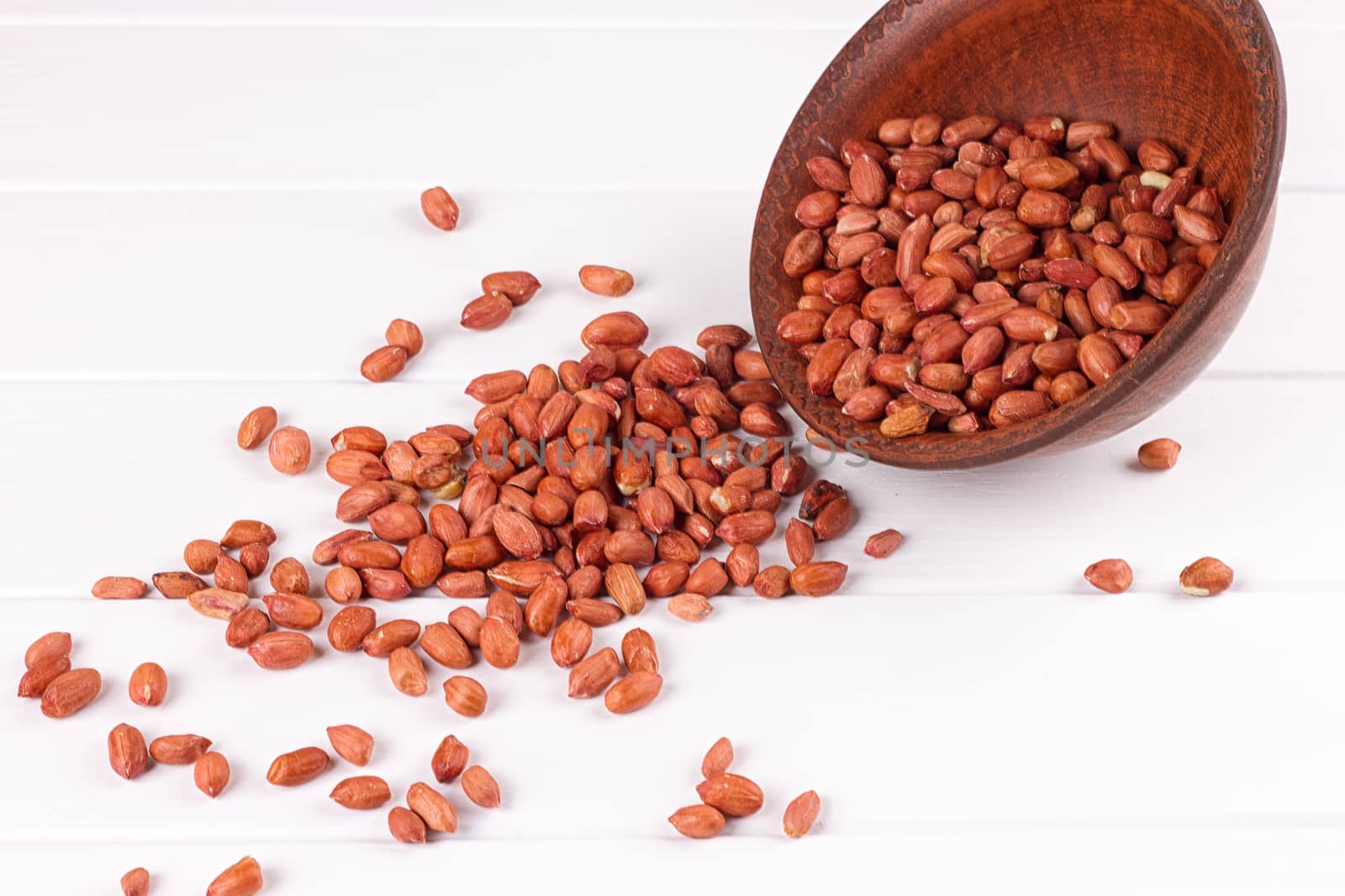 Peanuts in a brown plate. on white background