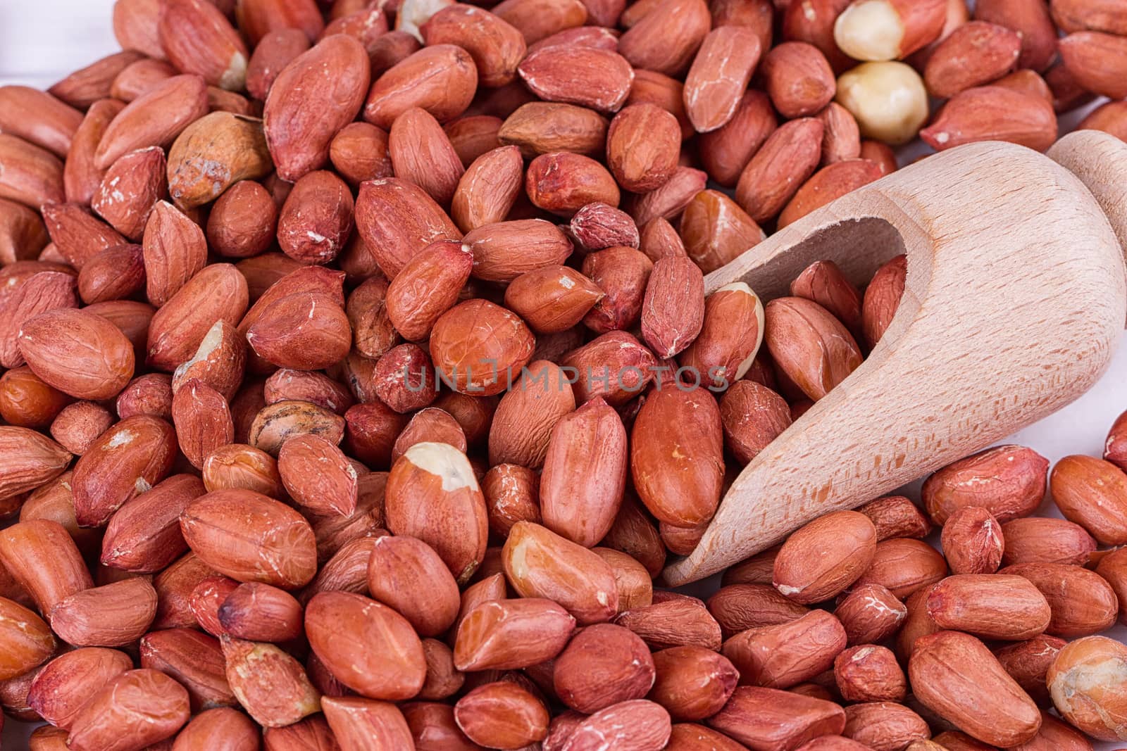 roasted peanuts with spatula close up photo