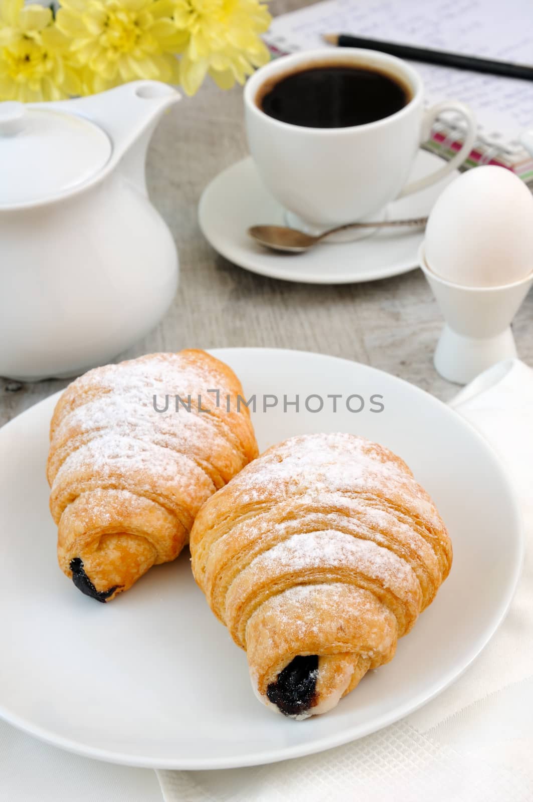 Croissants with chocolate filling cup and fresh morning coffee. 