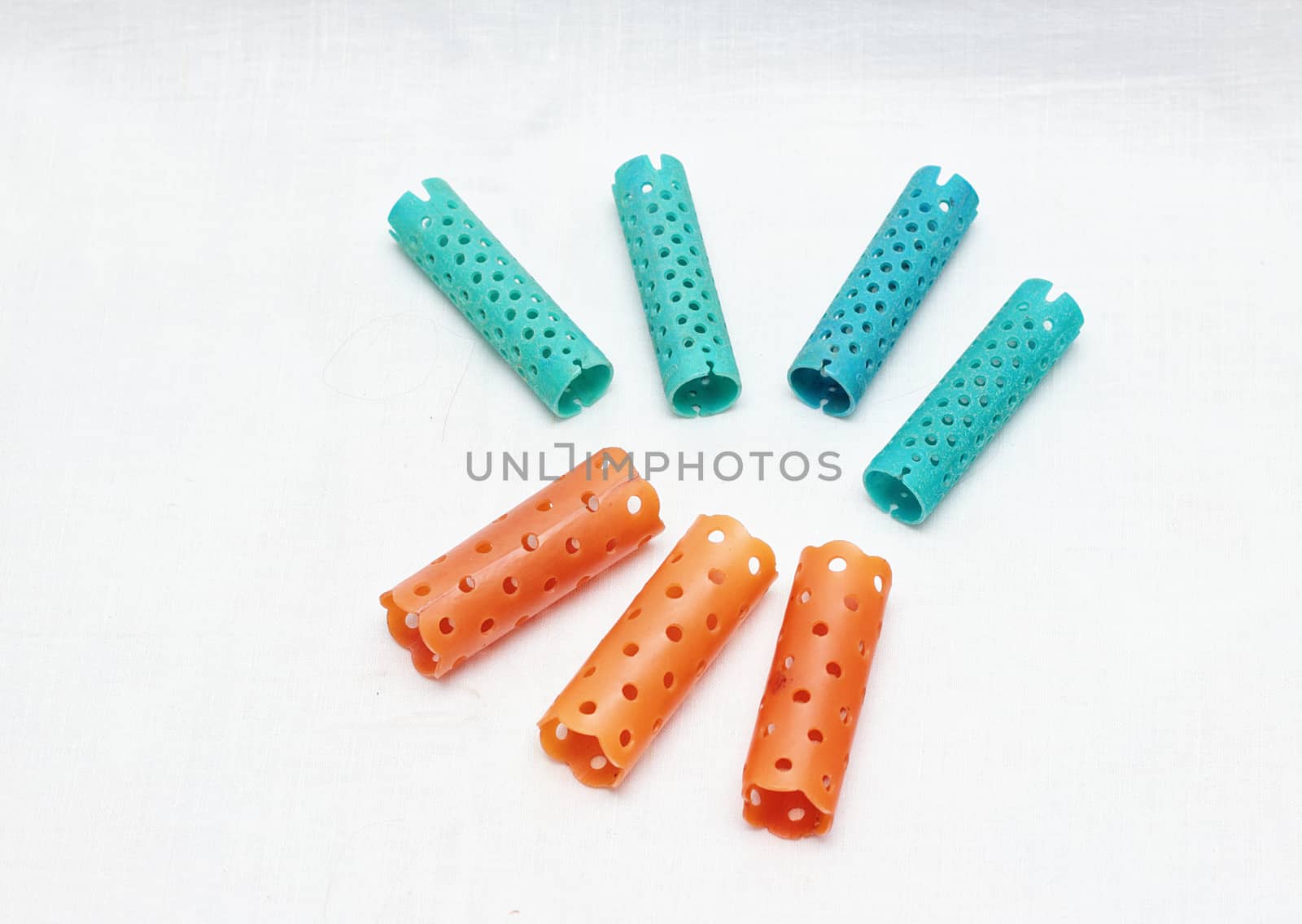 Set of colored female curlers isolated on white background.