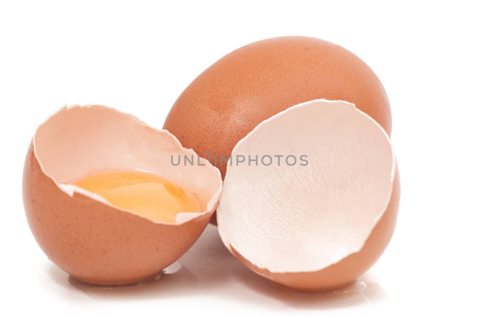 cracked egg with yolk isolated on a white background.