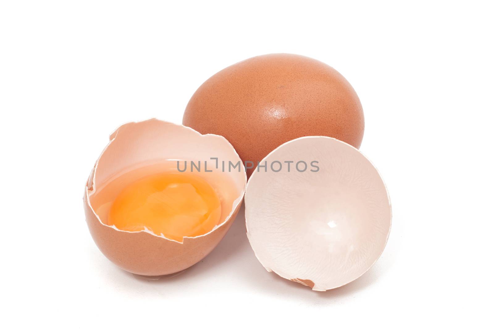 cracked egg with yolk isolated on a white background.
