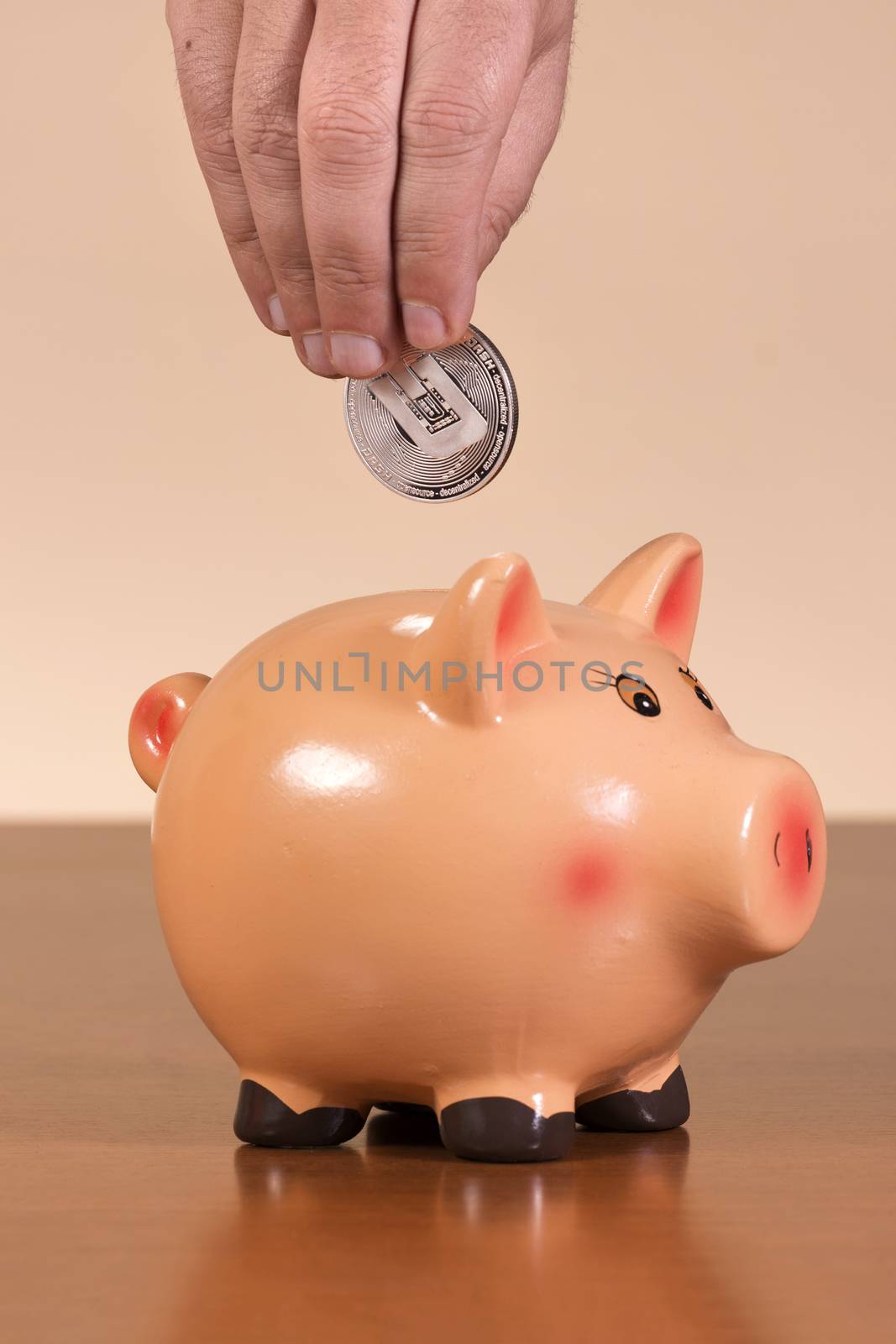 man inserts dash coin in piggy bank by membio