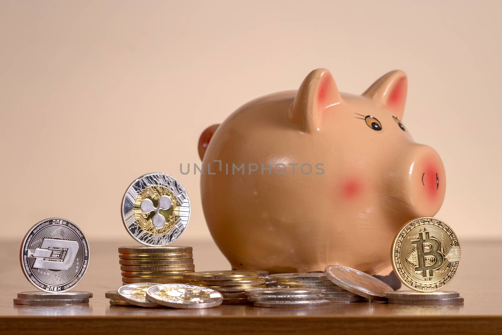 Piggy bank with several crypto currency coins by membio