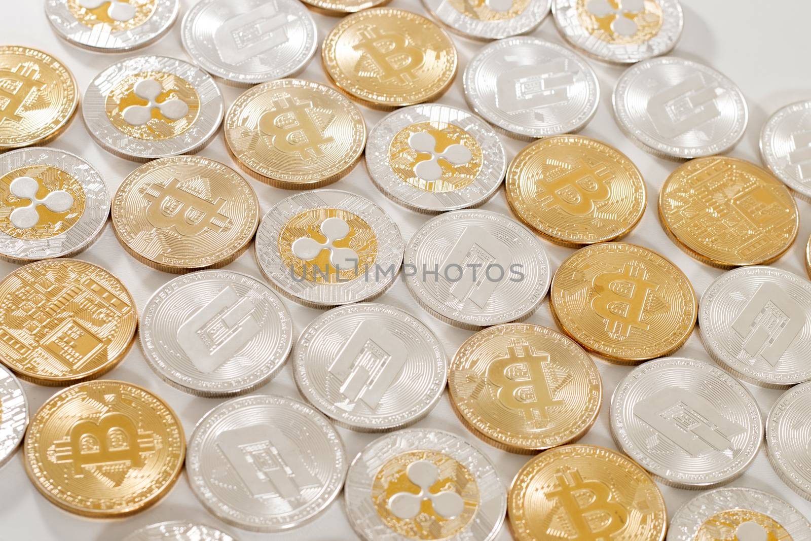 several aligned crypto currency coins on a white background.