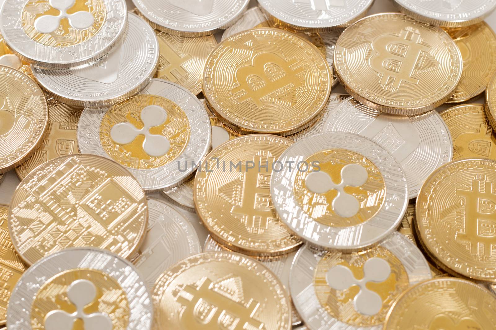 several aligned crypto currency coins on a white background.