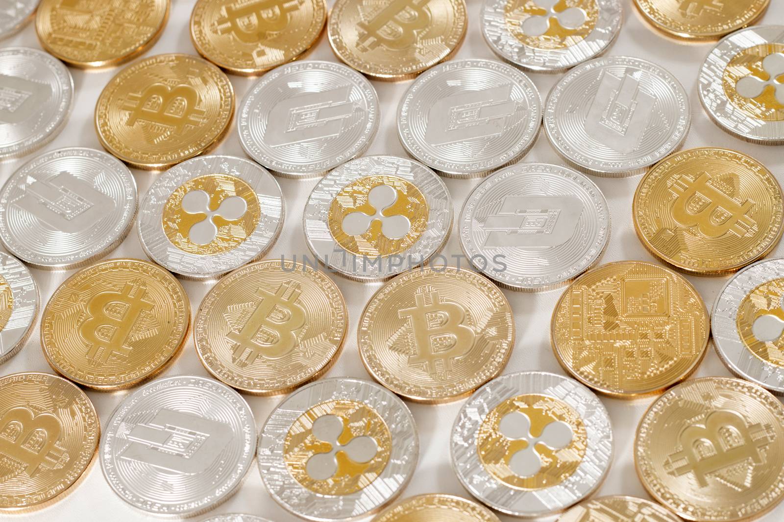 several aligned crypto currency coins on a white background.