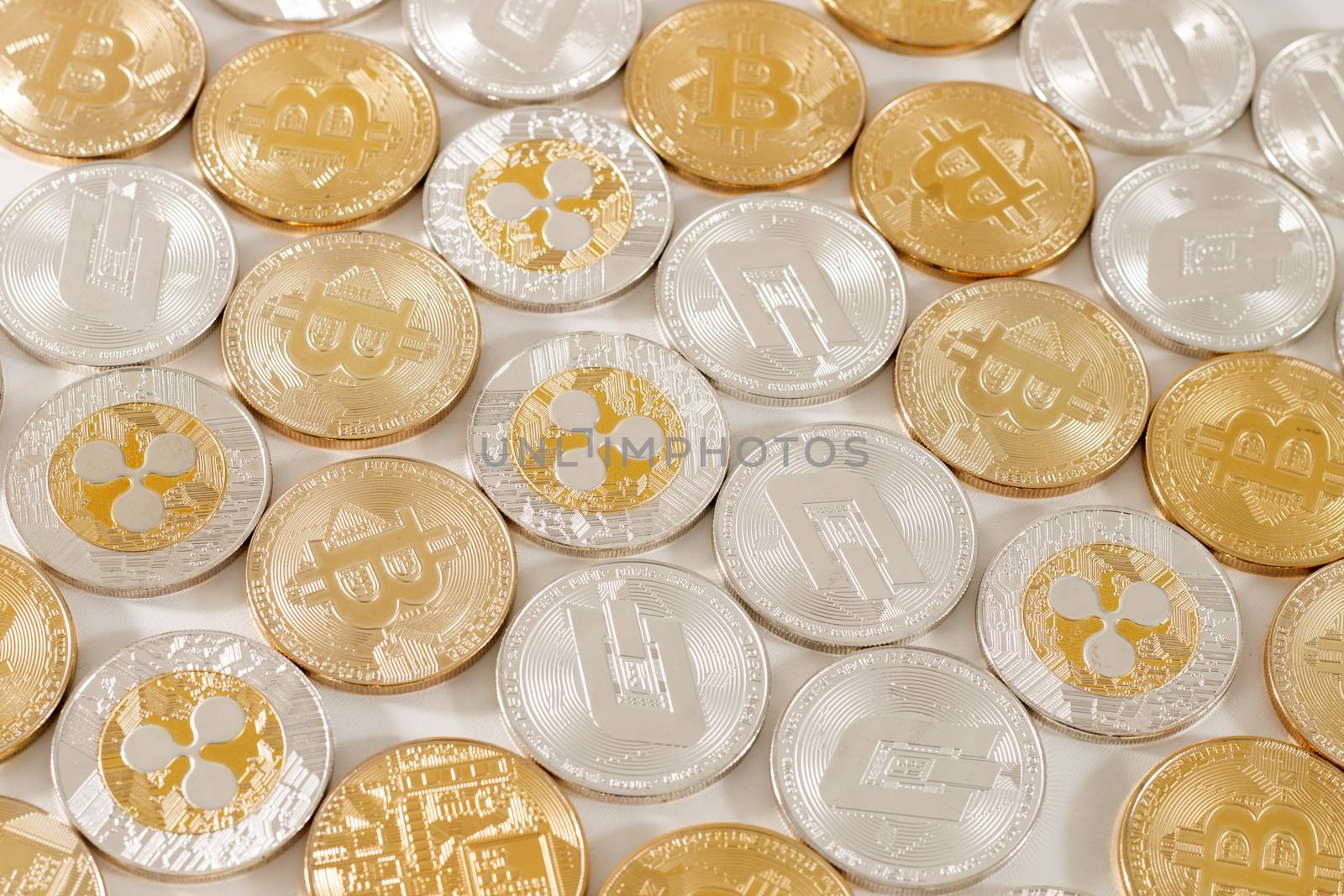 several aligned crypto currency coins on a white background.