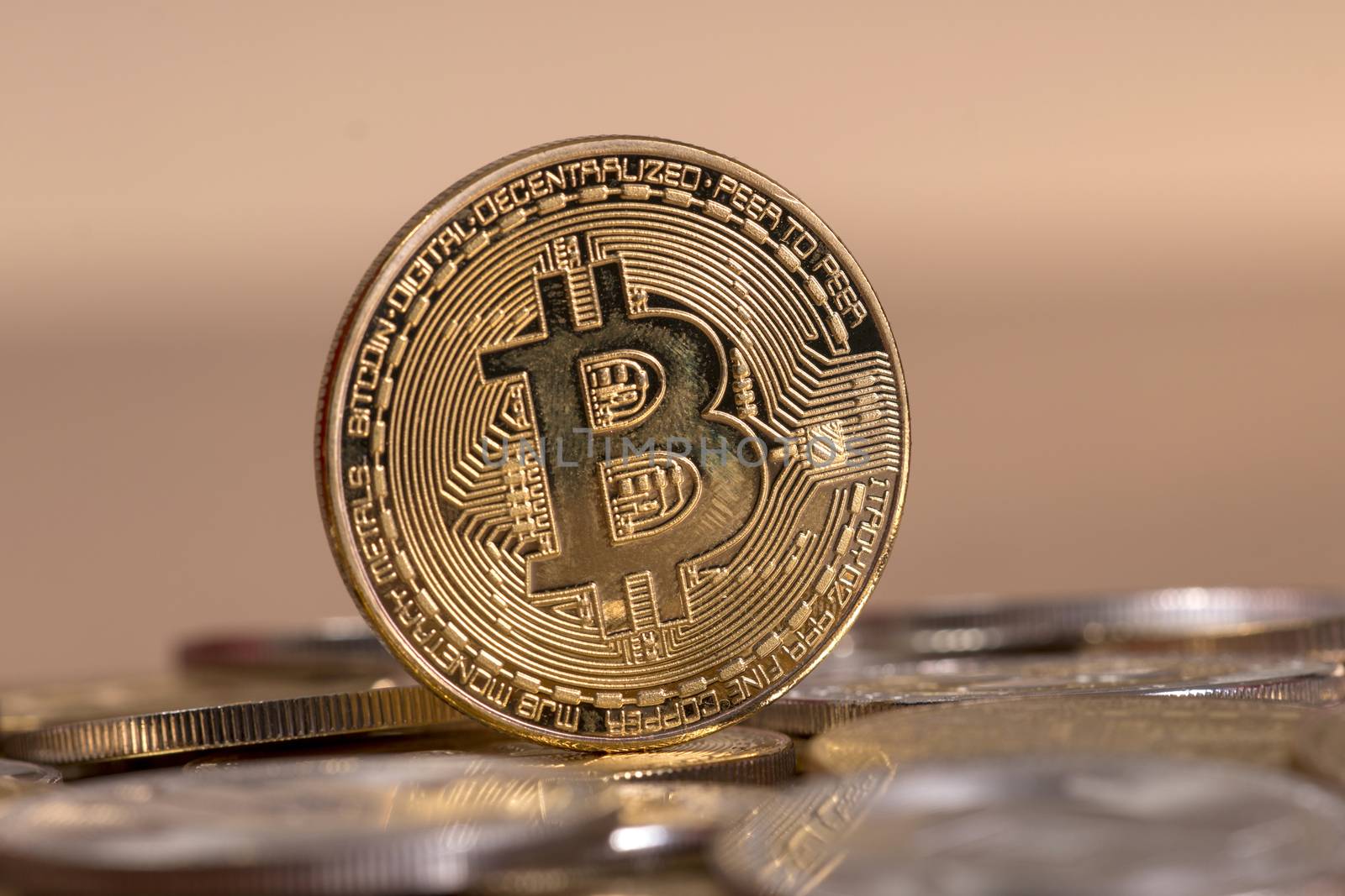 several aligned crypto currency coins on top of wooden table.