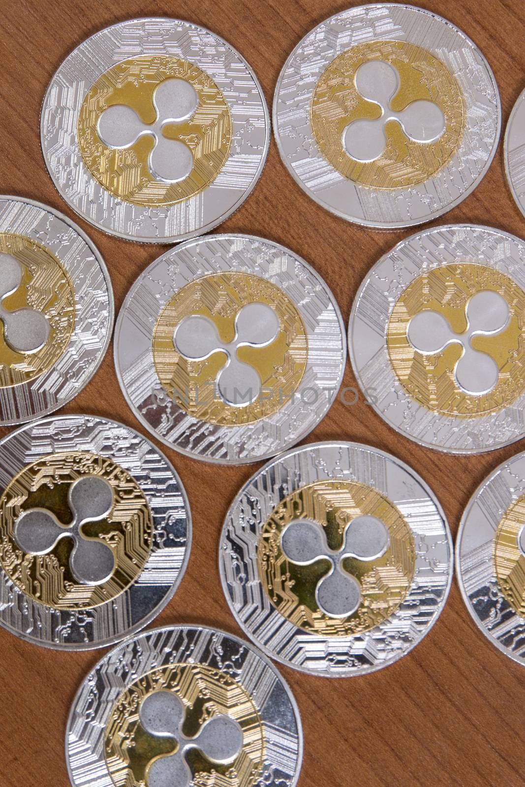 several aligned ripple coins on top of wooden table.