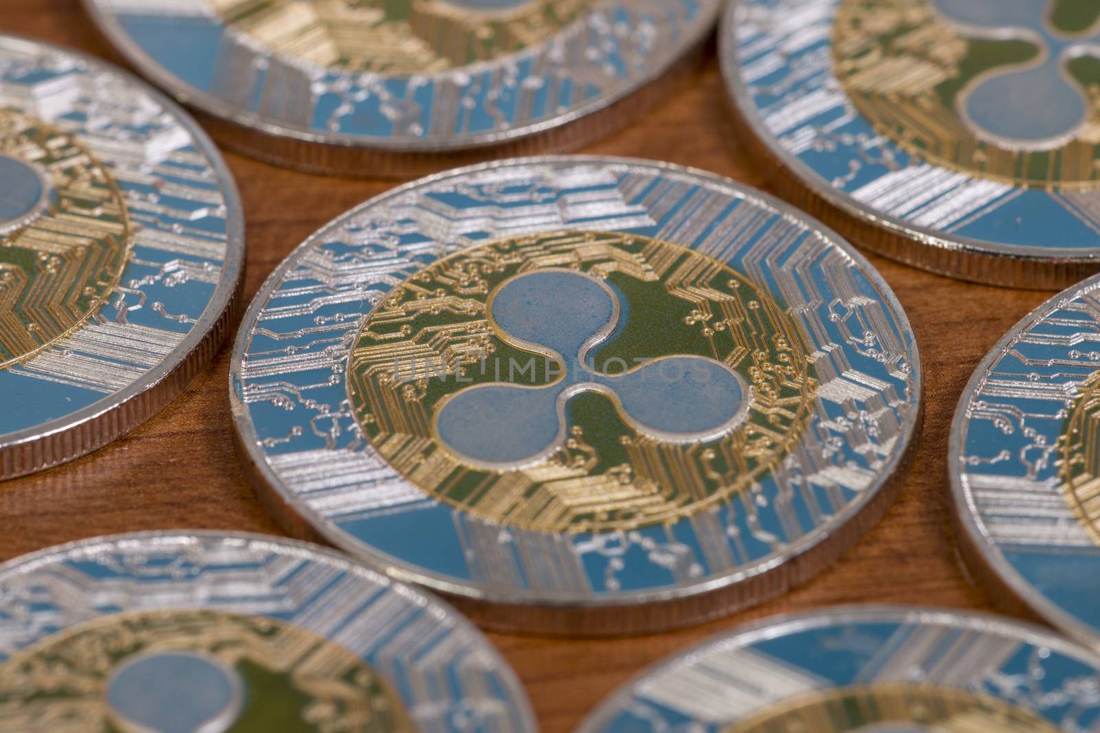 several aligned ripple coins on top of wooden table.