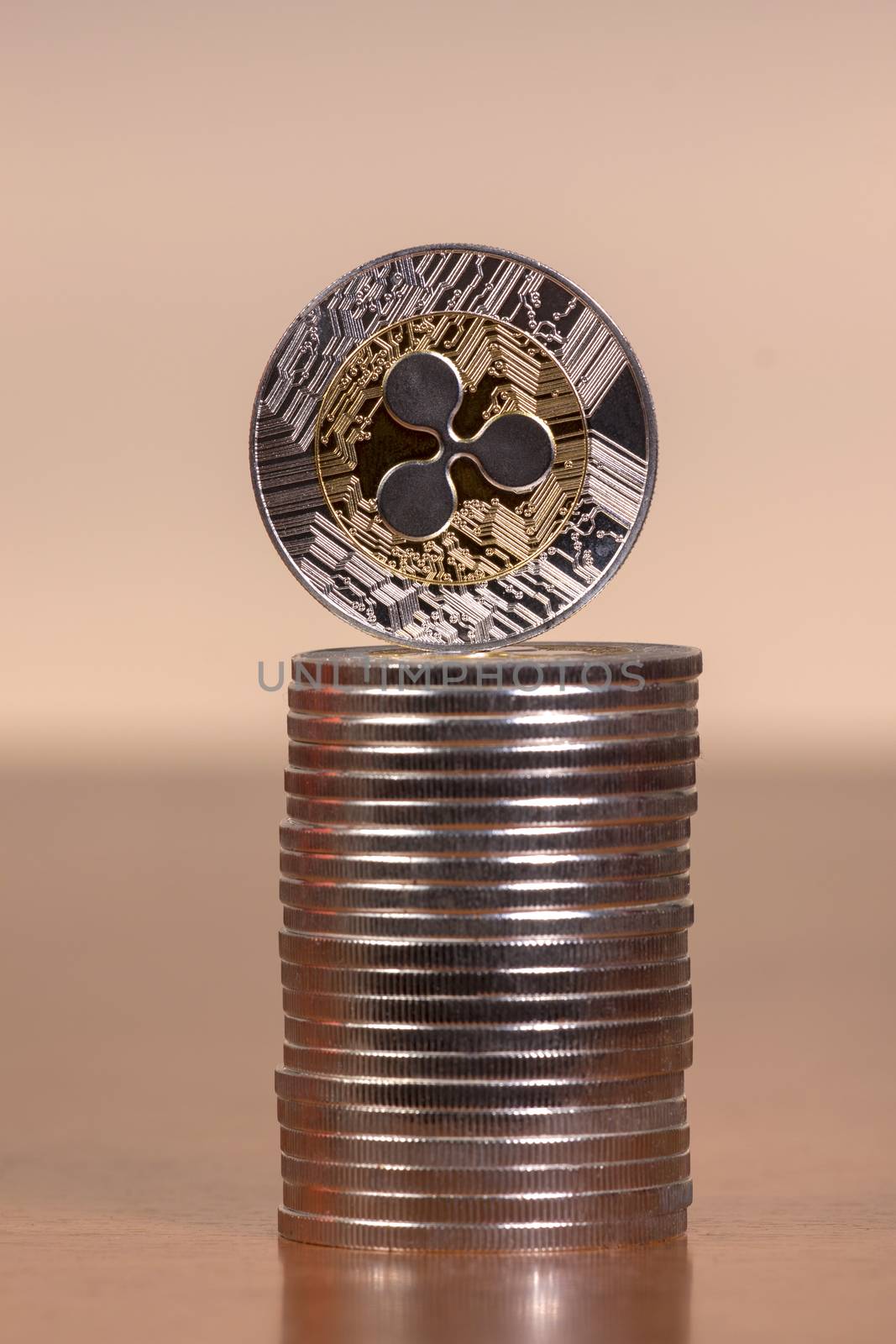 several aligned ripple coins on top of wooden table.