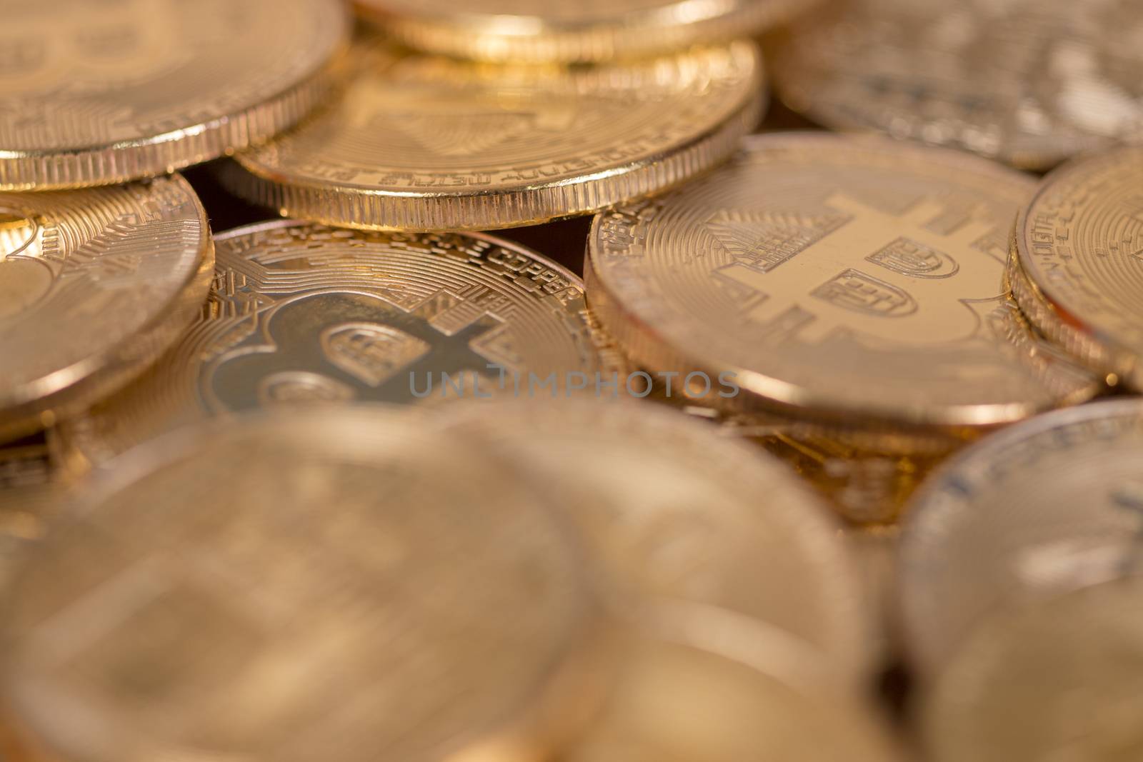 several golden bitcoins on top of wooden table.