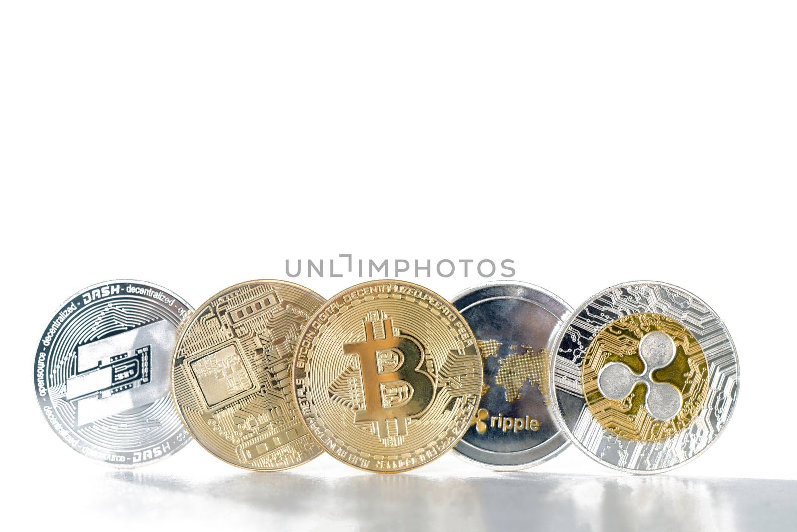 Shiny crypto currency coins on a white background.
