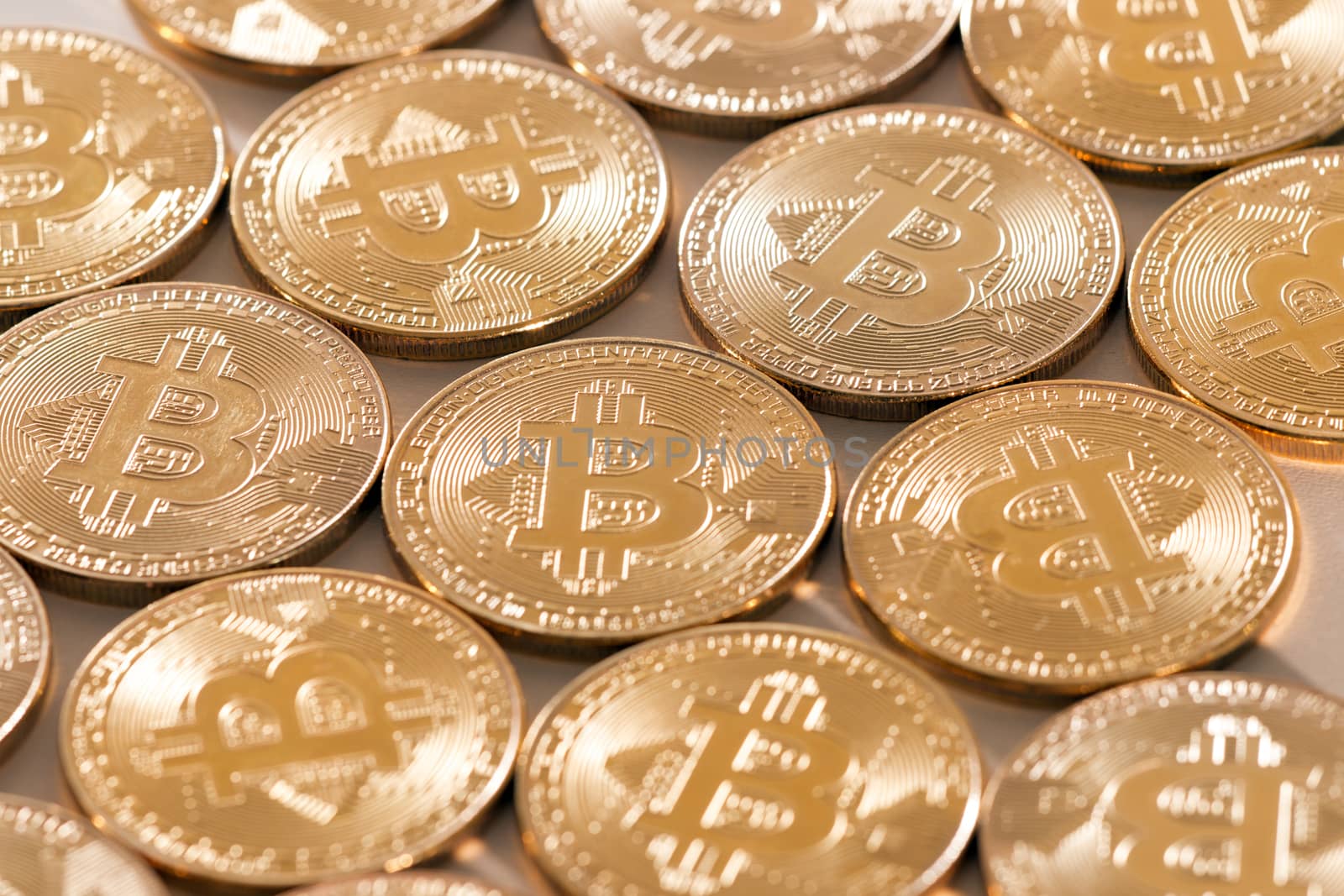 Shiny golden bitcoins on a white background.