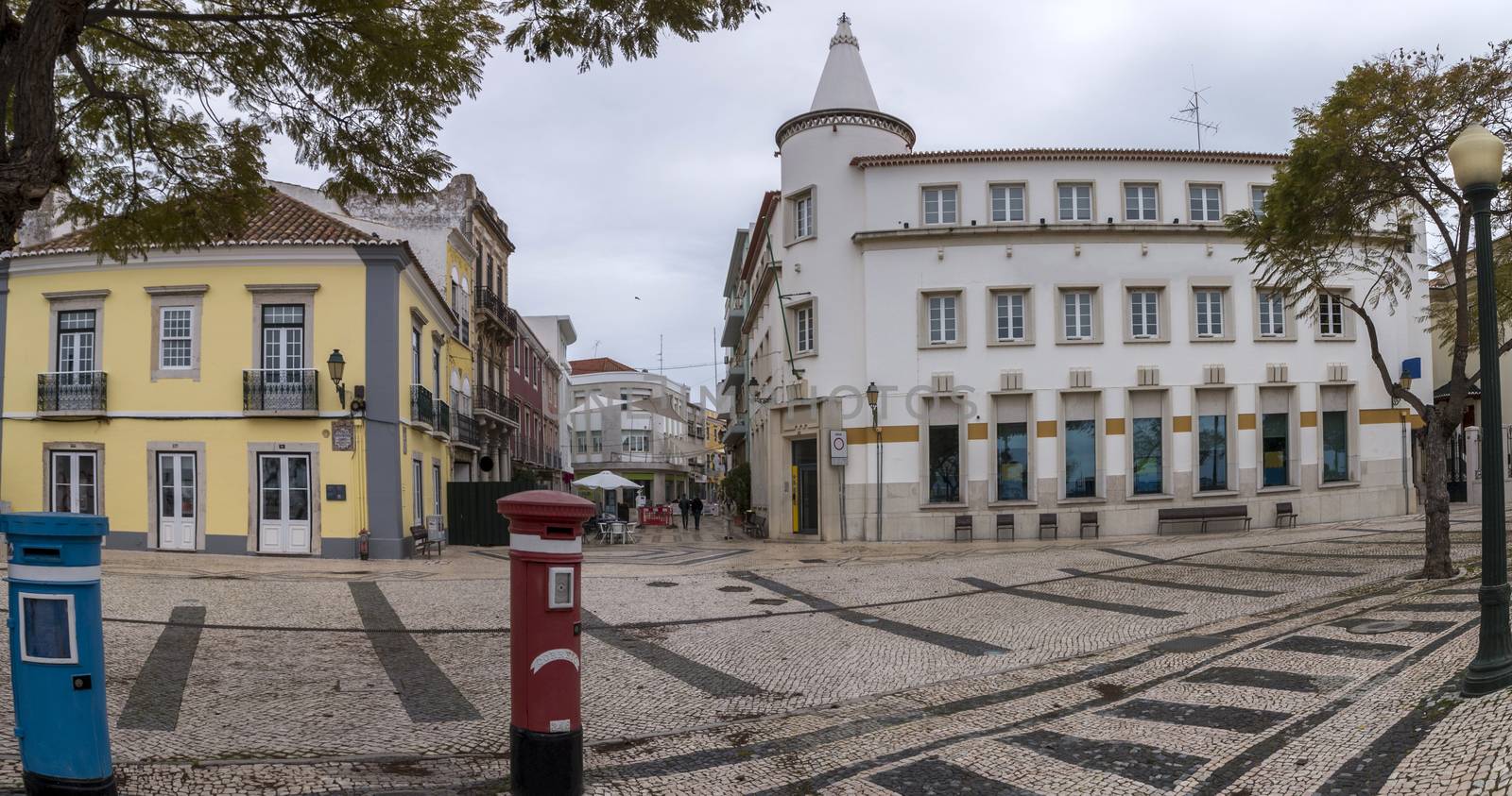Tourist area downtown of Faro city with cobblestone streets and stores.
