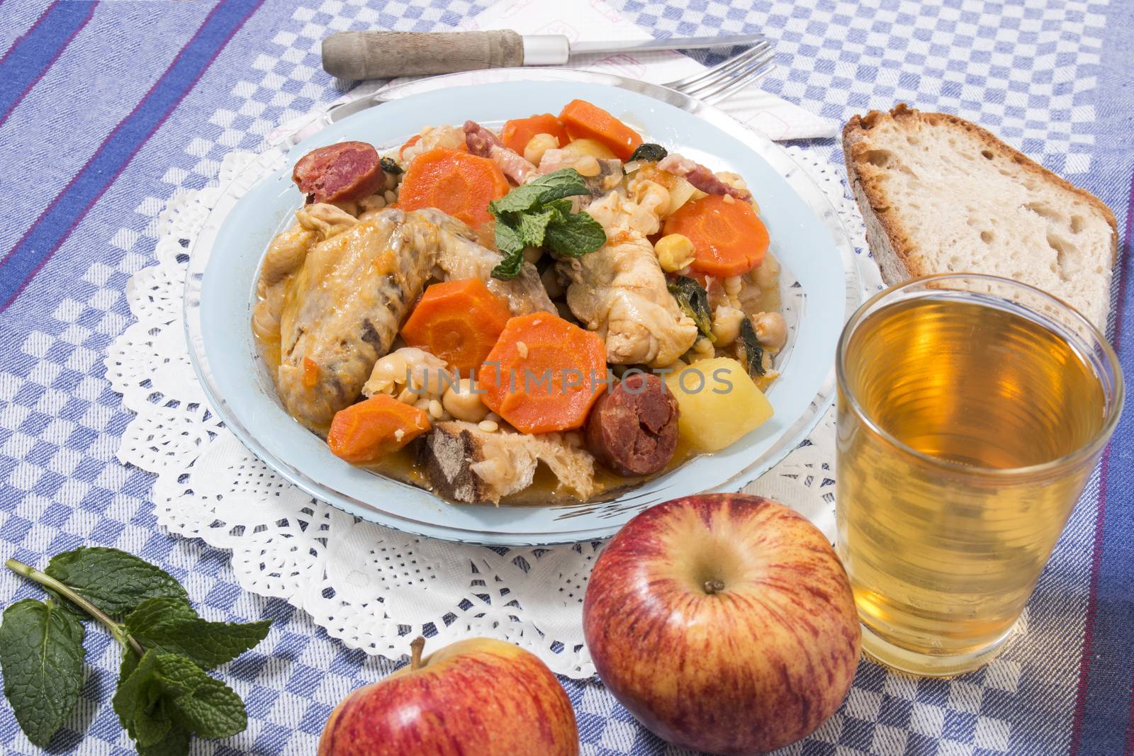 Traditional portuguese meal of Chickpeas with chicken, carrot and chorizo.