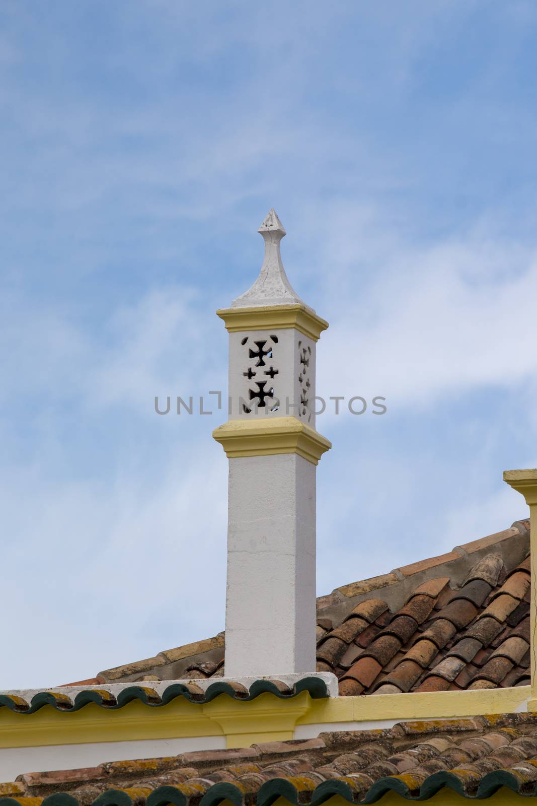 Typical chimney on brown tile roofs in Portuguese architecture.