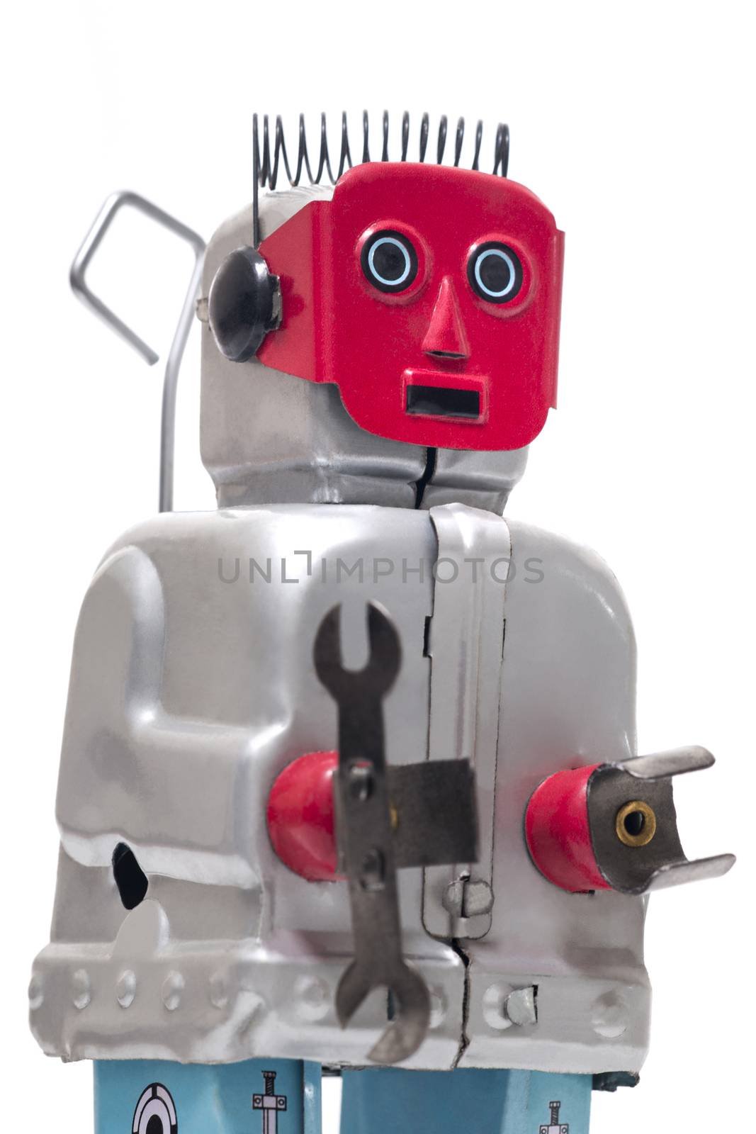 Vintage retro red face tin toy robot isolated on a white background.