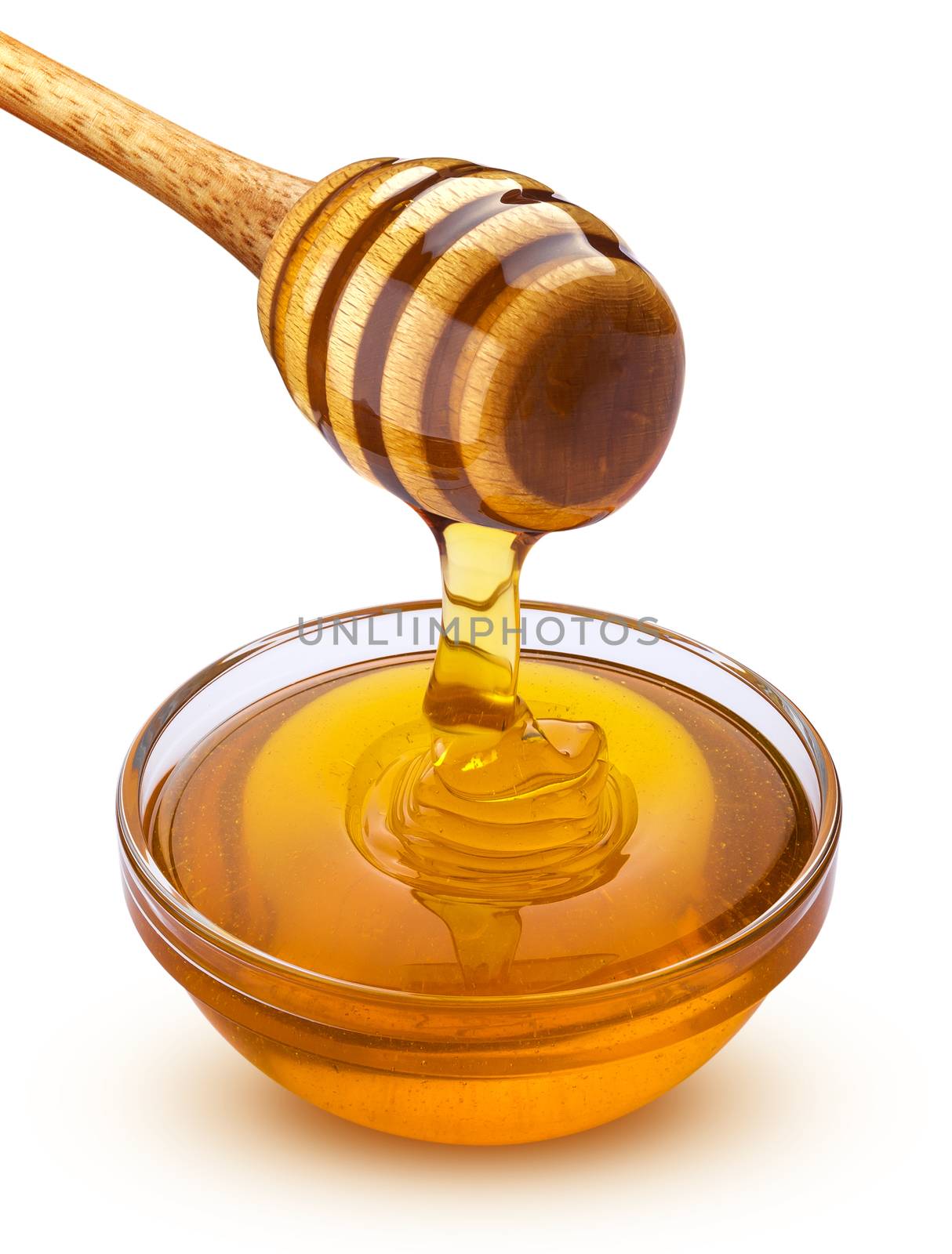 Honey dipper and bowl of pouring honey isolated on white background with clipping path