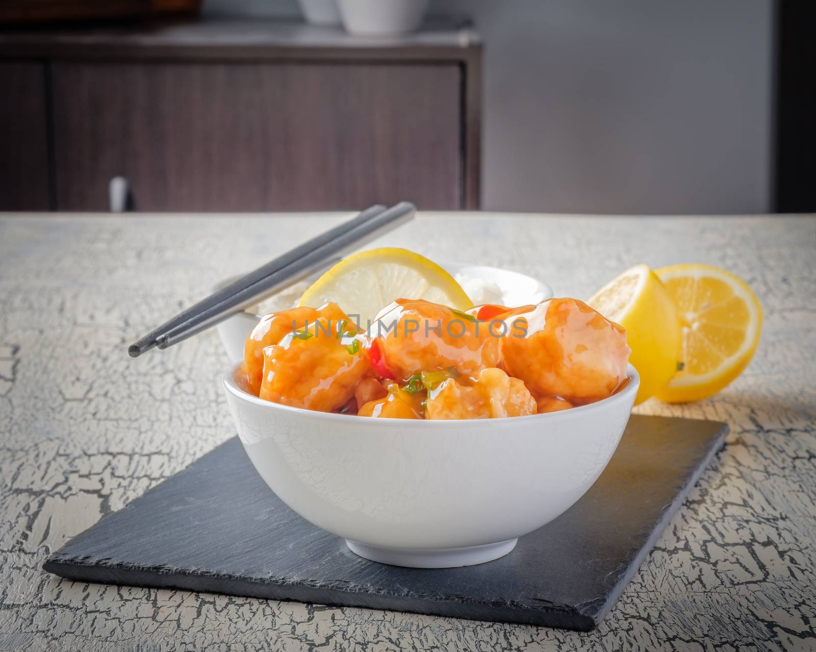 Bowl of Asian lemon chicken photographed closeup.