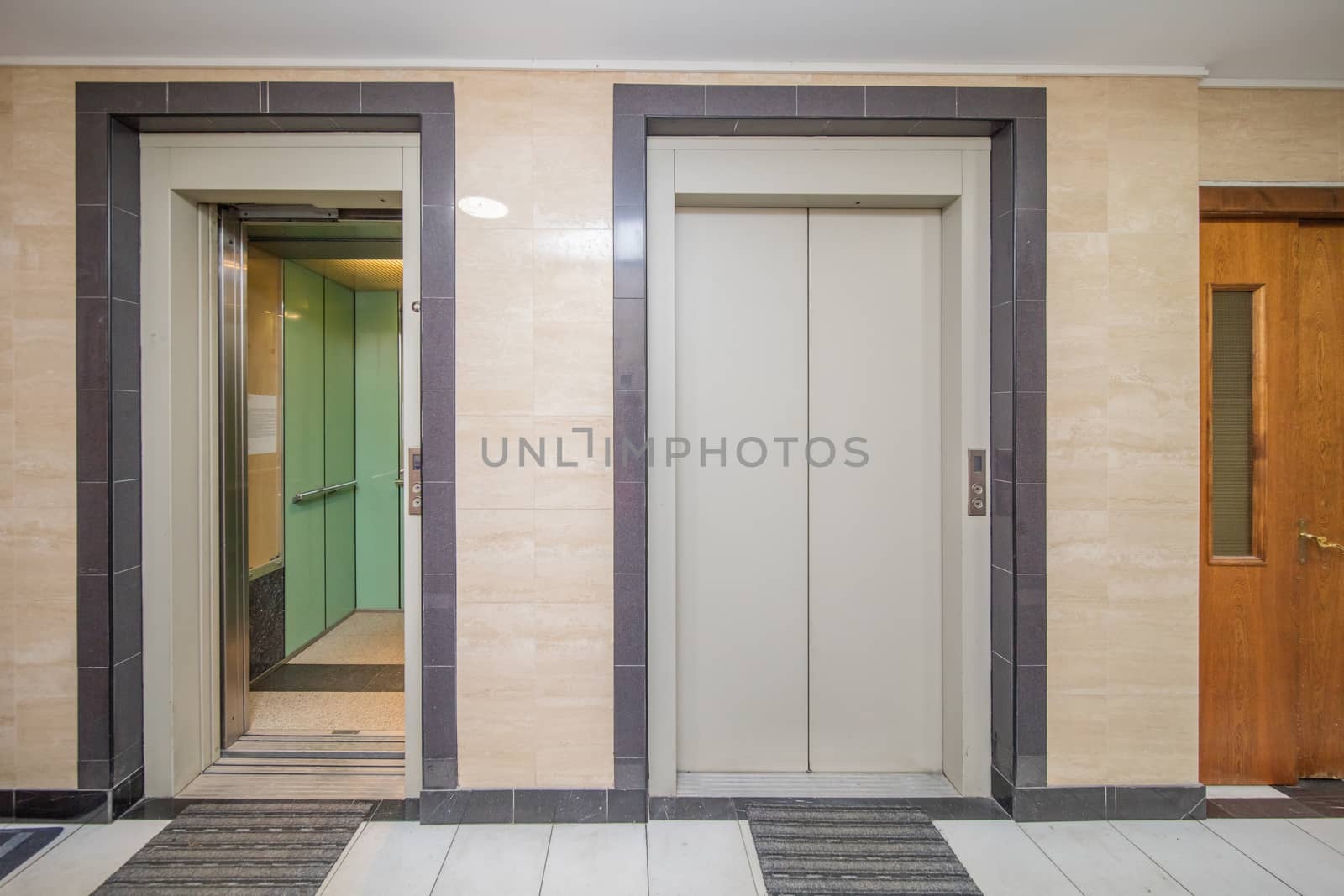 empty modern elevator or lift with open and closed metal doors