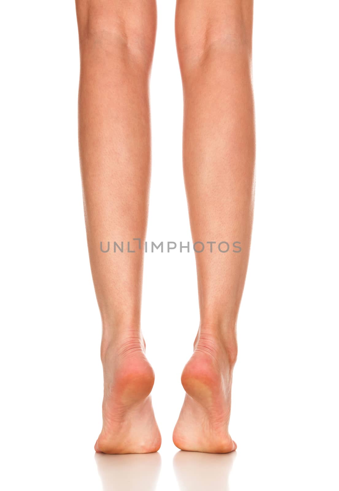 Closeup shot of female bare feet, isolated on white background