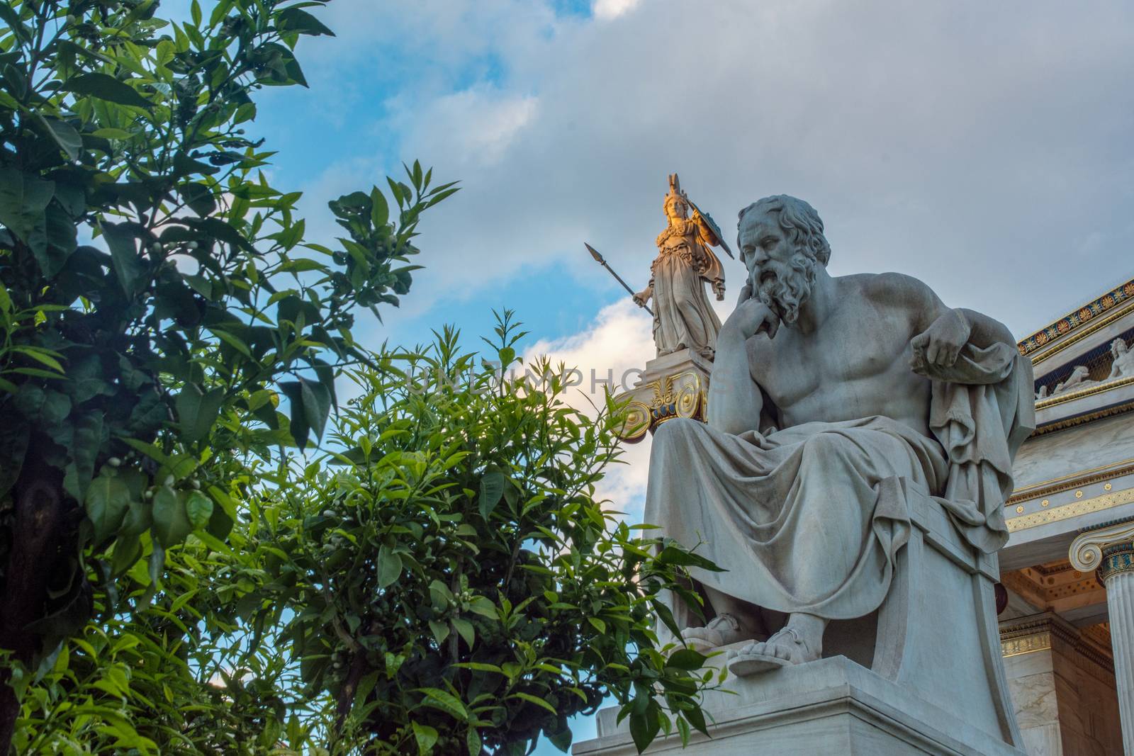 classical statue of Socrates from side with athena statue above