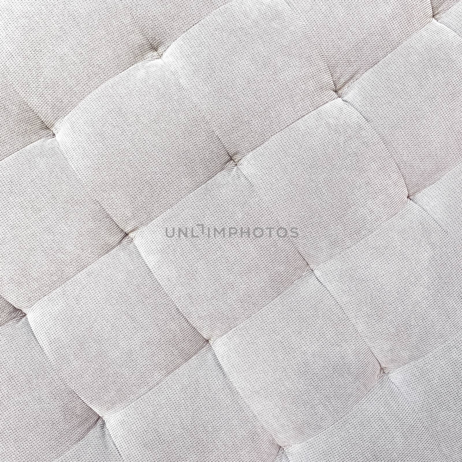 Gray buttoned fabric background. Detail of a textile ottoman. Classic style furniture. 