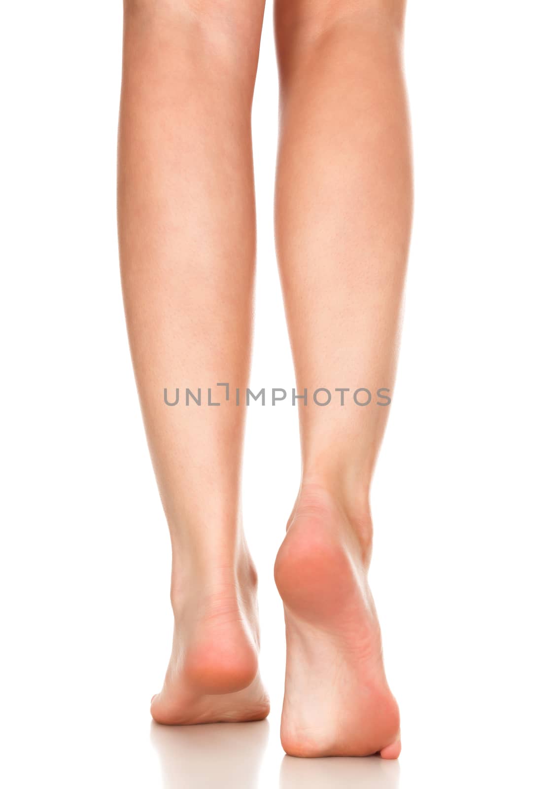 Closeup shot of female bare feet, isolated on white background