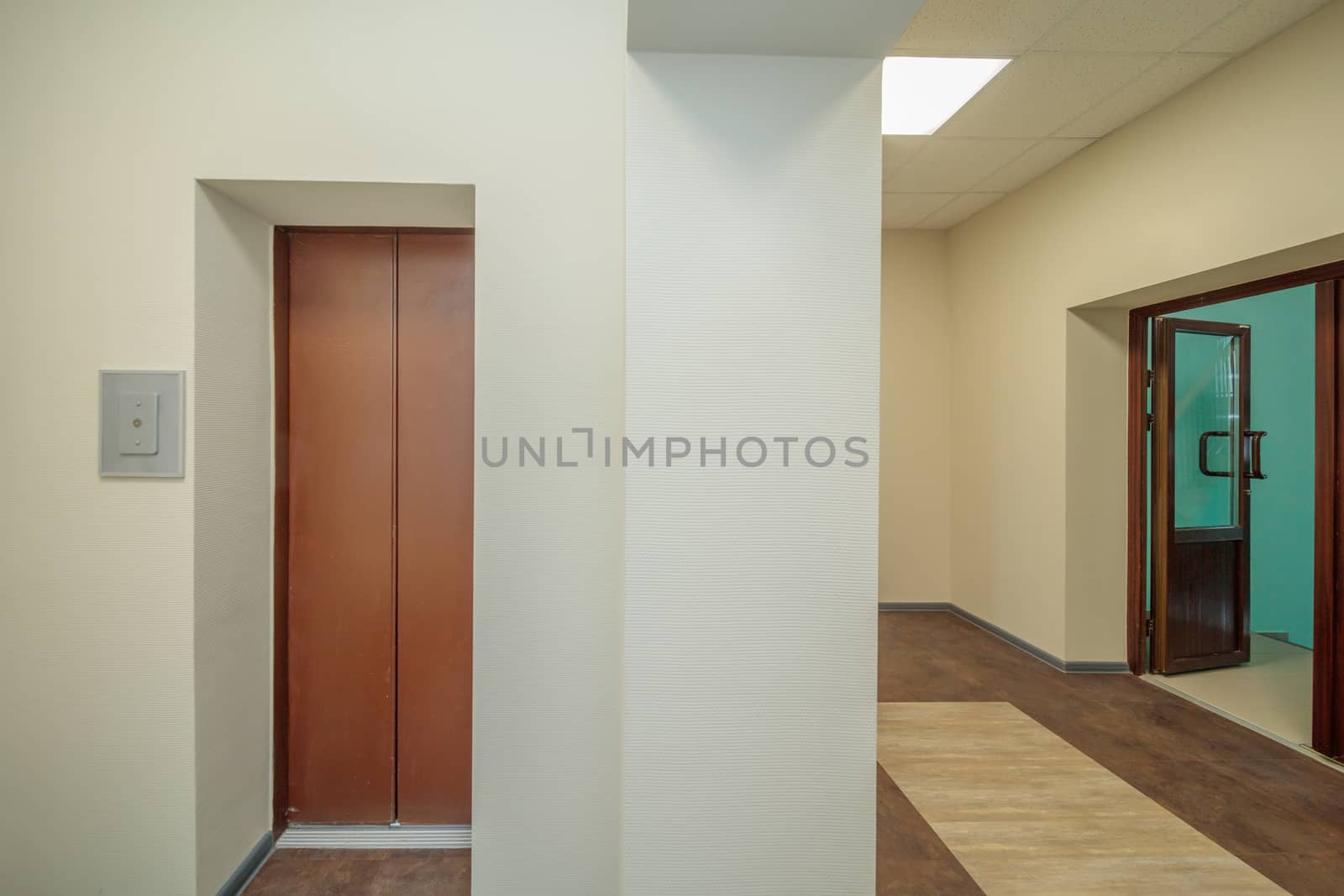 empty modern elevator or lift with open and closed metal doors