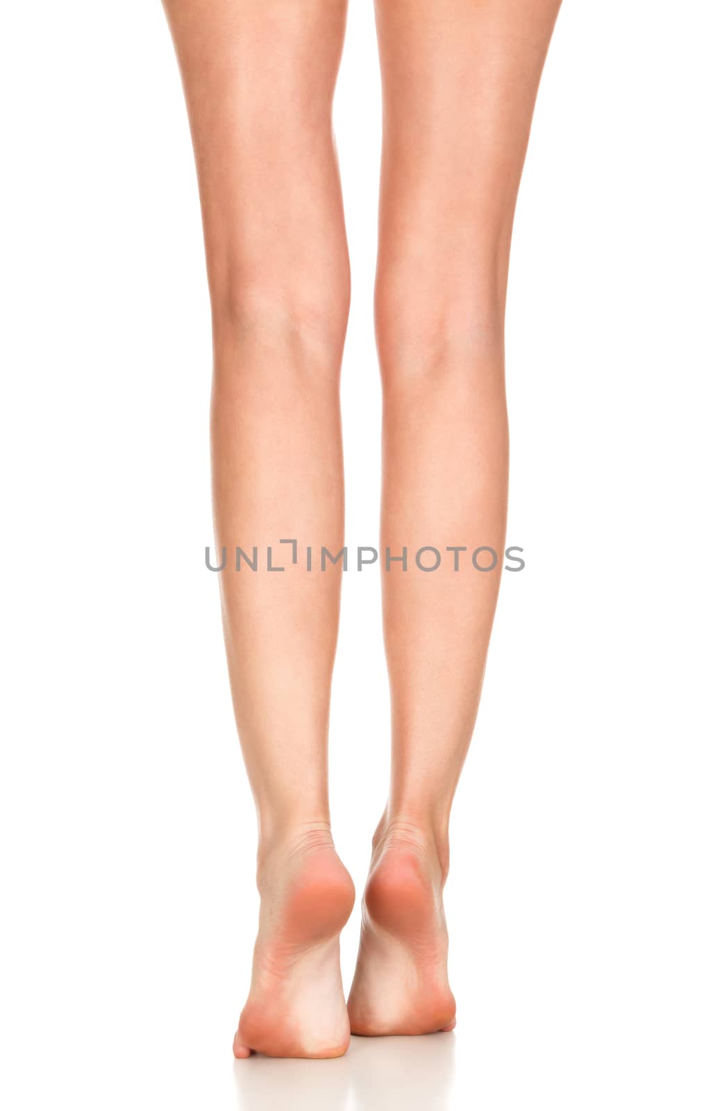 Closeup shot of female bare feet, isolated on white background