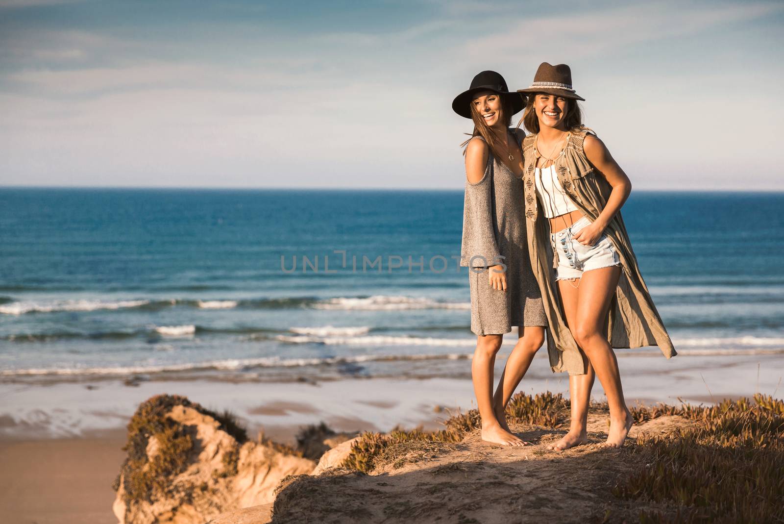 Two best friends near the coastline having fun on a beautiful summer day