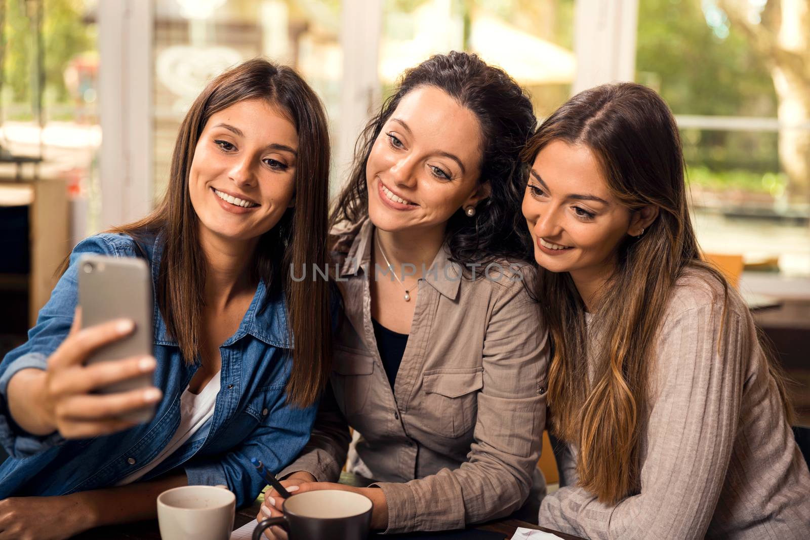 Groups of female firends making a selfie during a pause on the studies