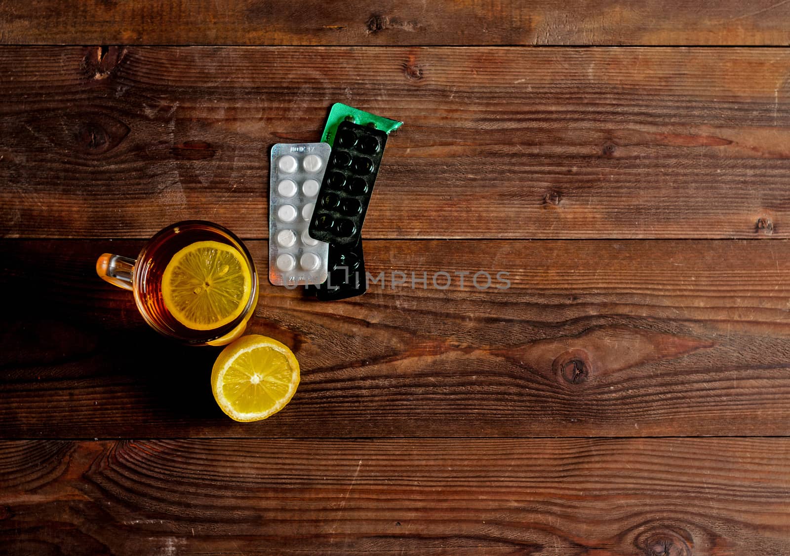 Seasonal flu: pills, tea with lemon. View from above