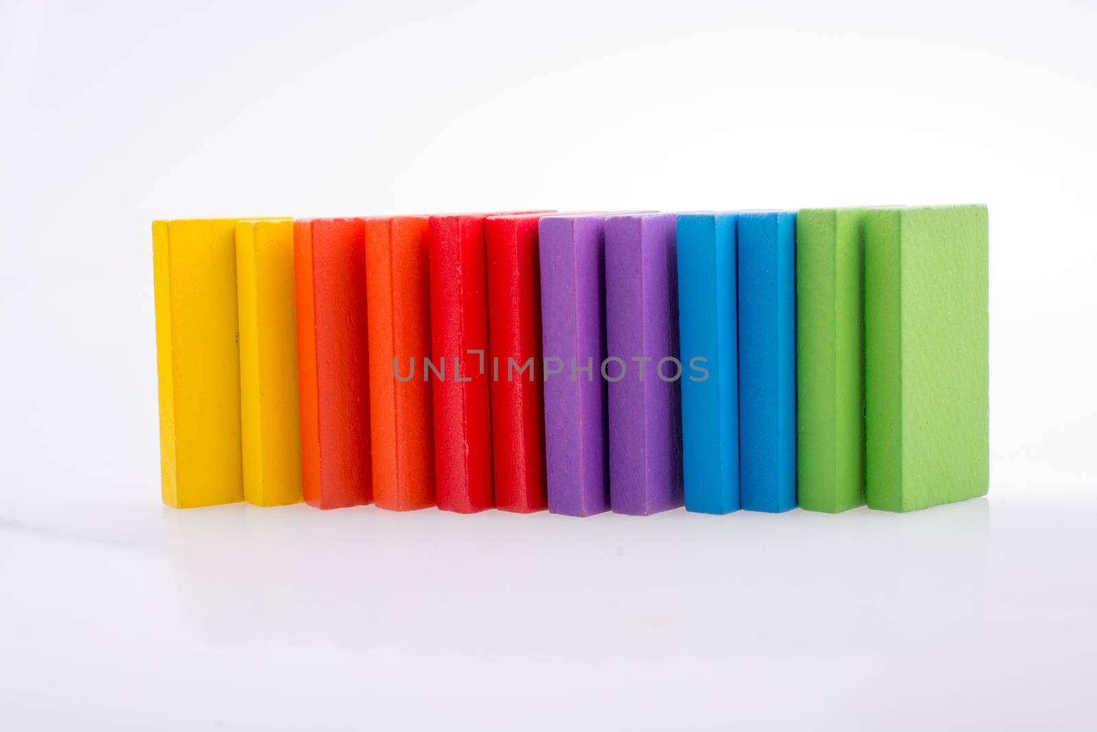 Colorful Domino Blocks in a line on a white background