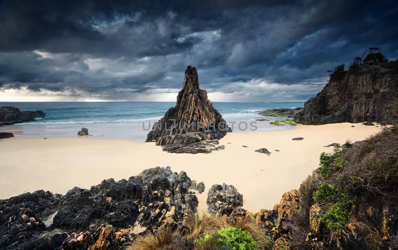 Formidable weather elements, moody storm clouds, rain and strong winds at the Pyramid rock sea stack