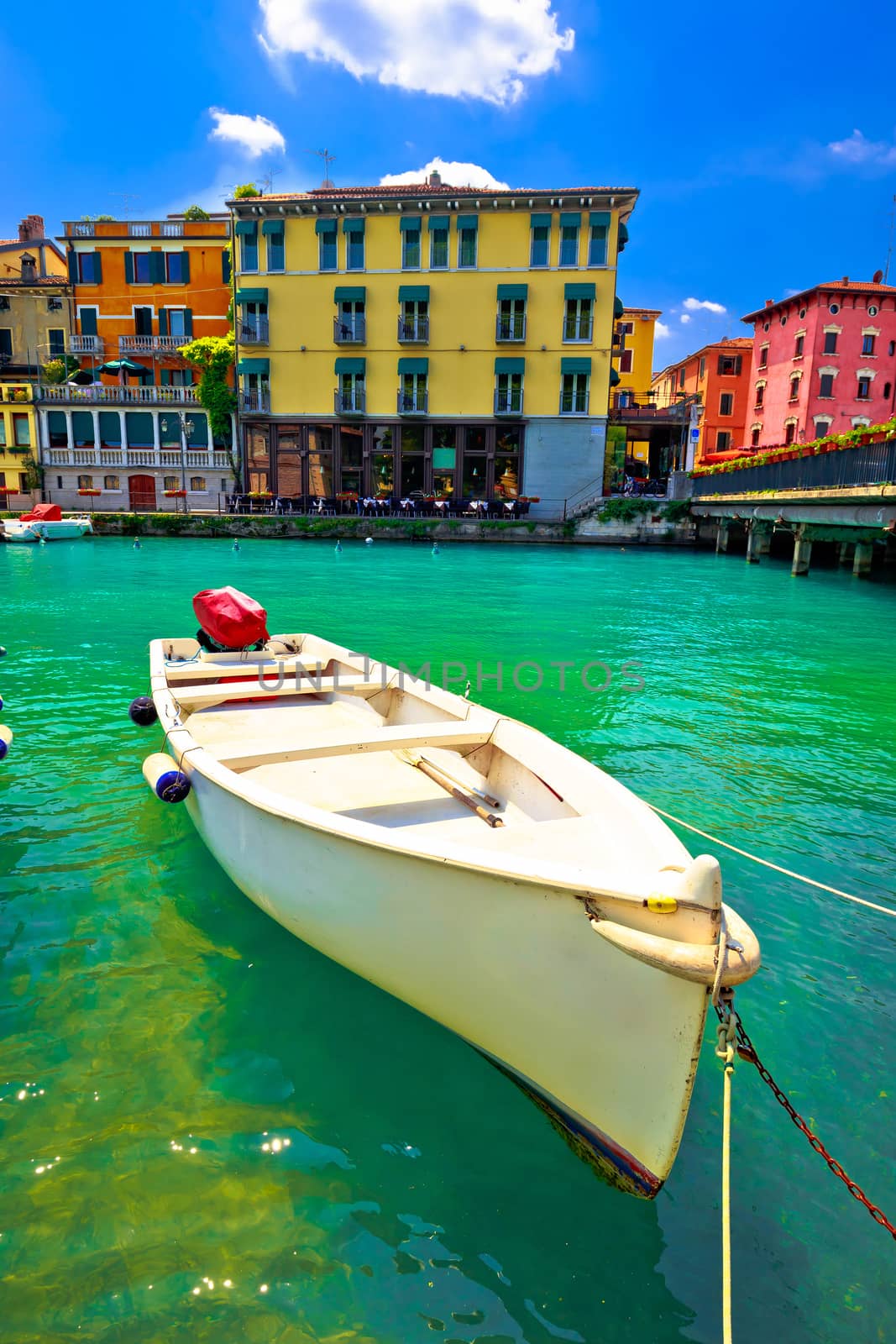 Peschiera del Garda colorful harbor and boats vertical view, Lago di Garda, Veneto region of Italy