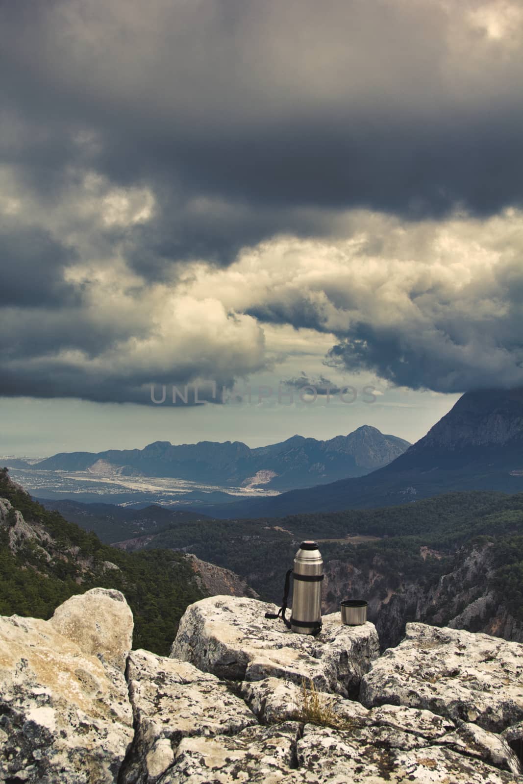 Vintage camera on rock and coffee cup in the morning with mountain view background